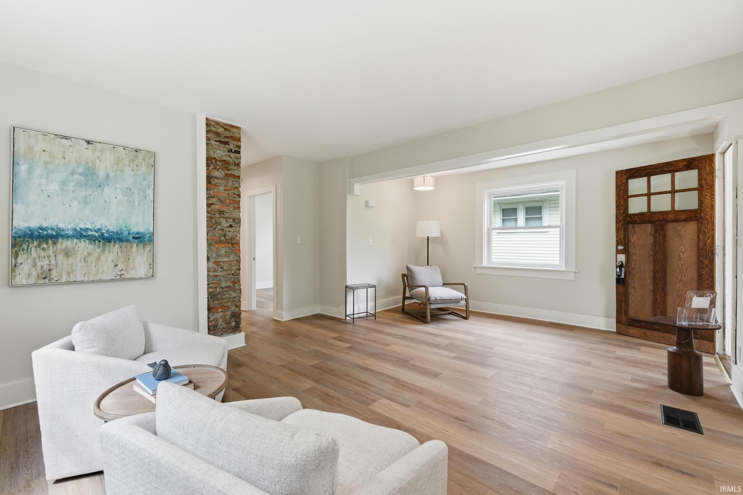 Living room with light wood finished floors and baseboards