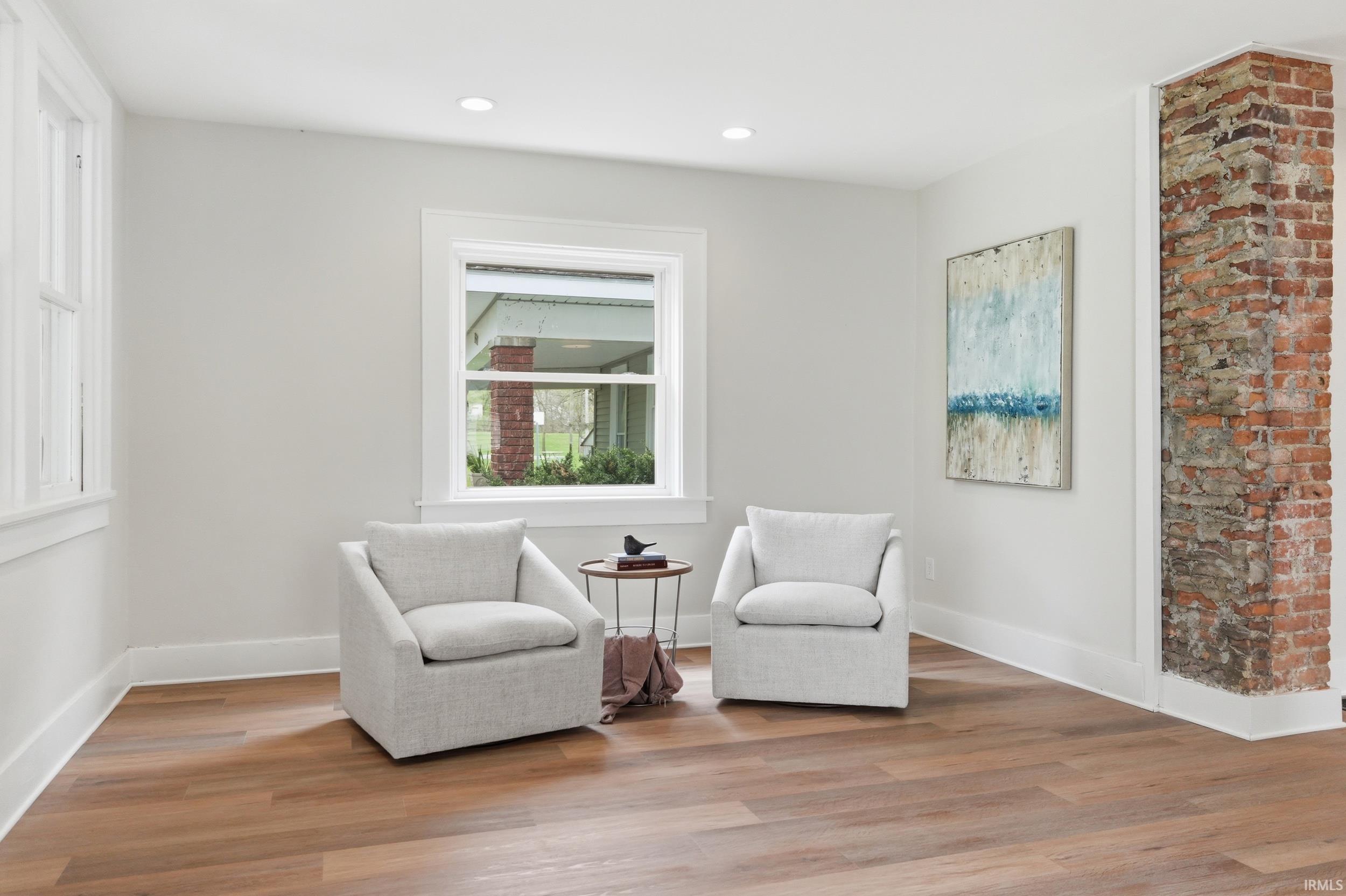 Living area featuring wood finished floors and recessed lighting