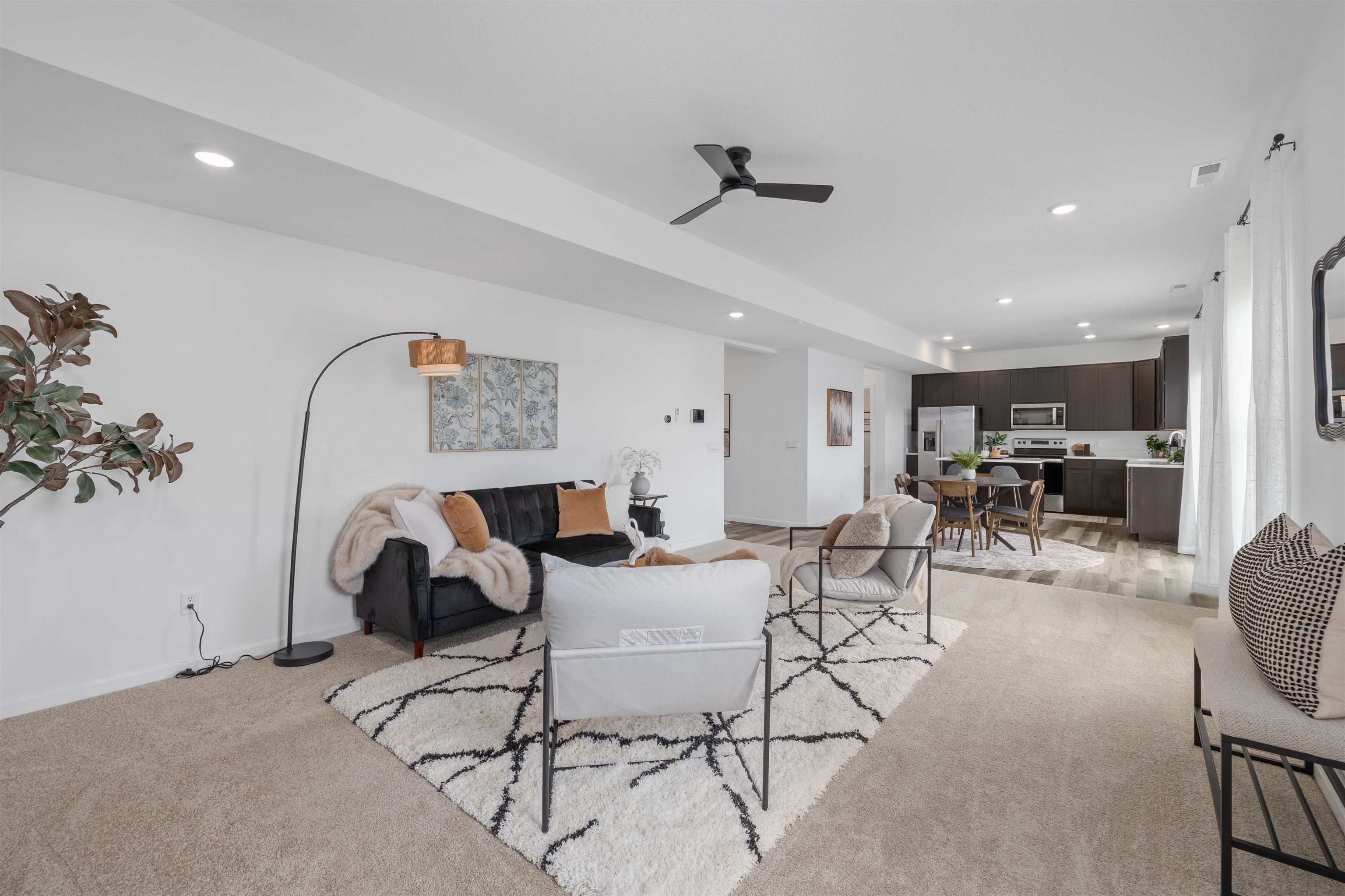 Open-concept living space featuring recessed lighting, a ceiling fan, and carpeted flooring