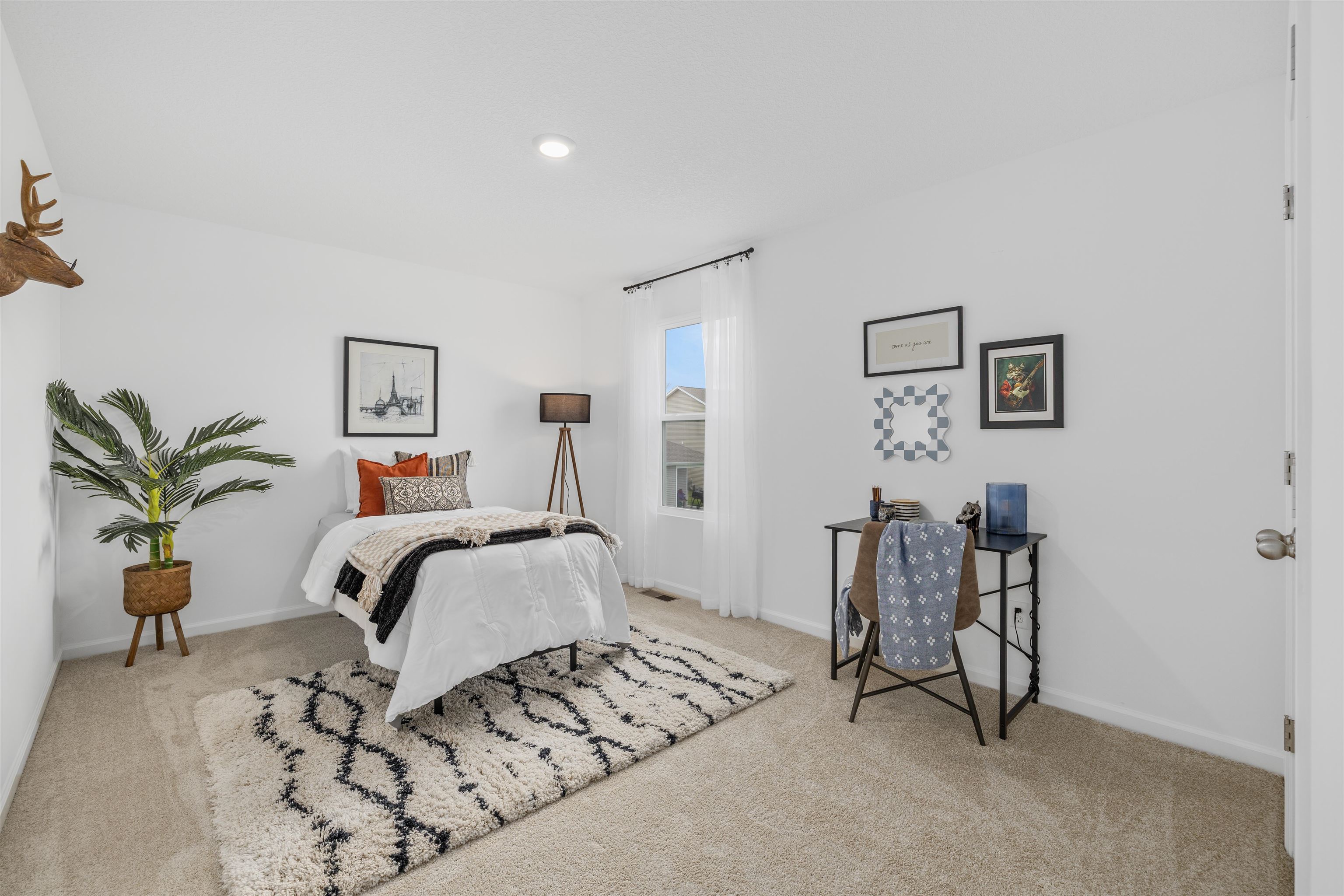 Carpeted room with recessed lighting and a single window featuring vertical blinds