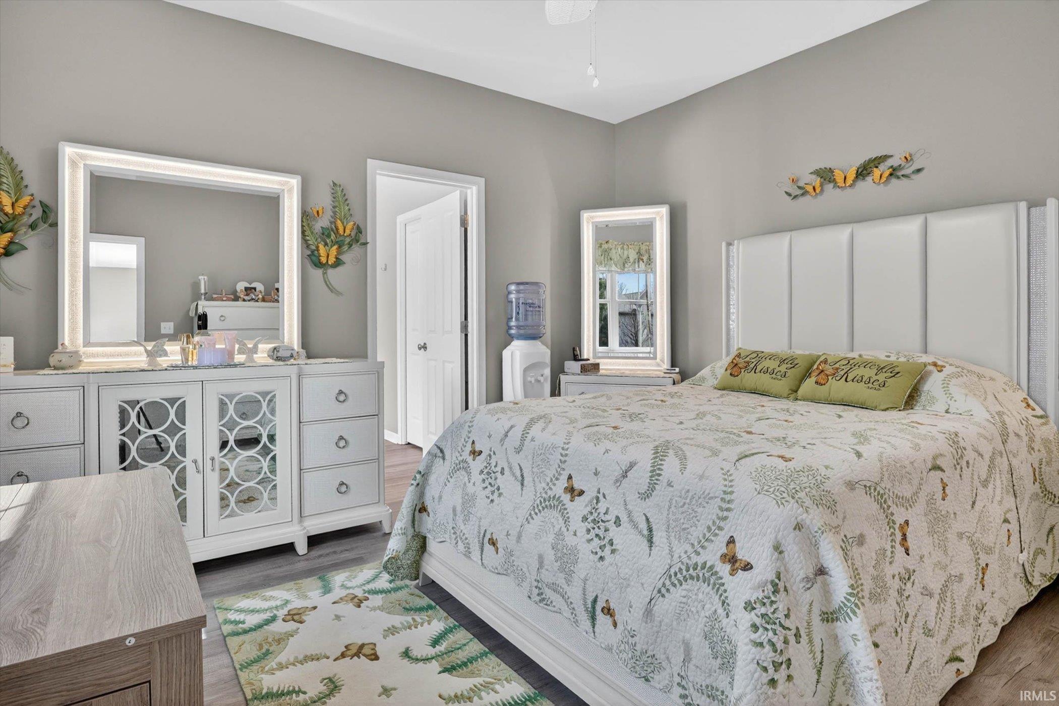 Bedroom with dark wood-style floors and ceiling fan