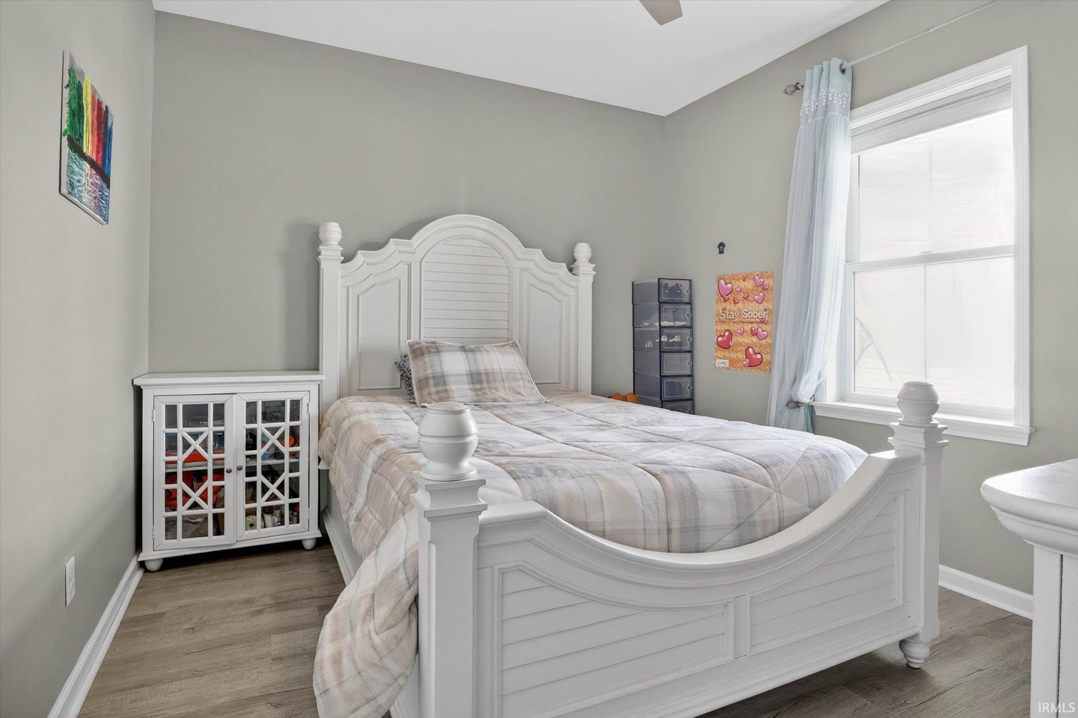 Bedroom featuring a ceiling fan and wood finished floors