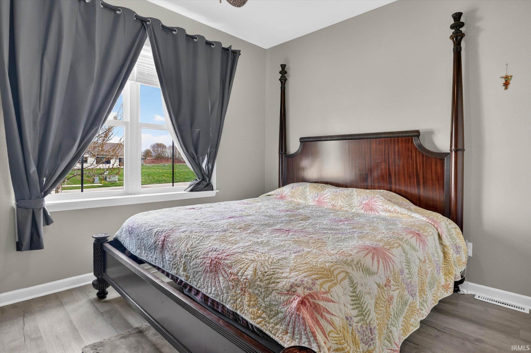 Bedroom featuring baseboards and wood finished floors