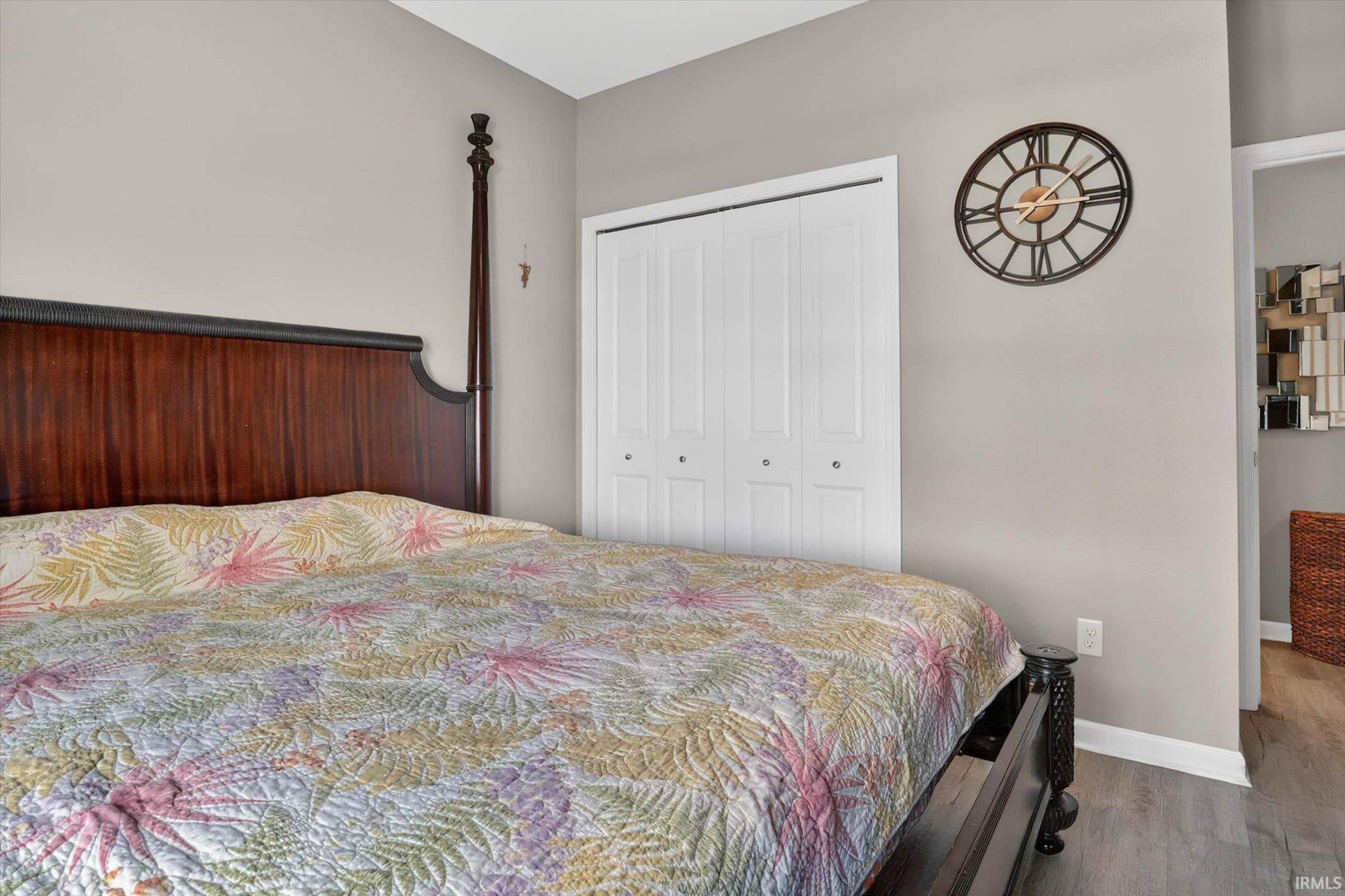 Bedroom featuring wood finished floors and a closet