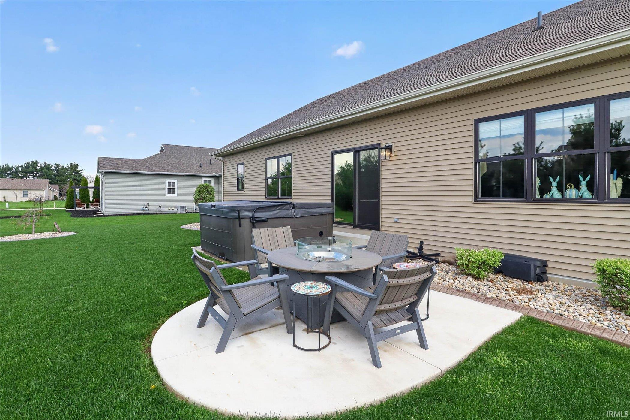 View of patio / terrace featuring a hot tub and outdoor dining space