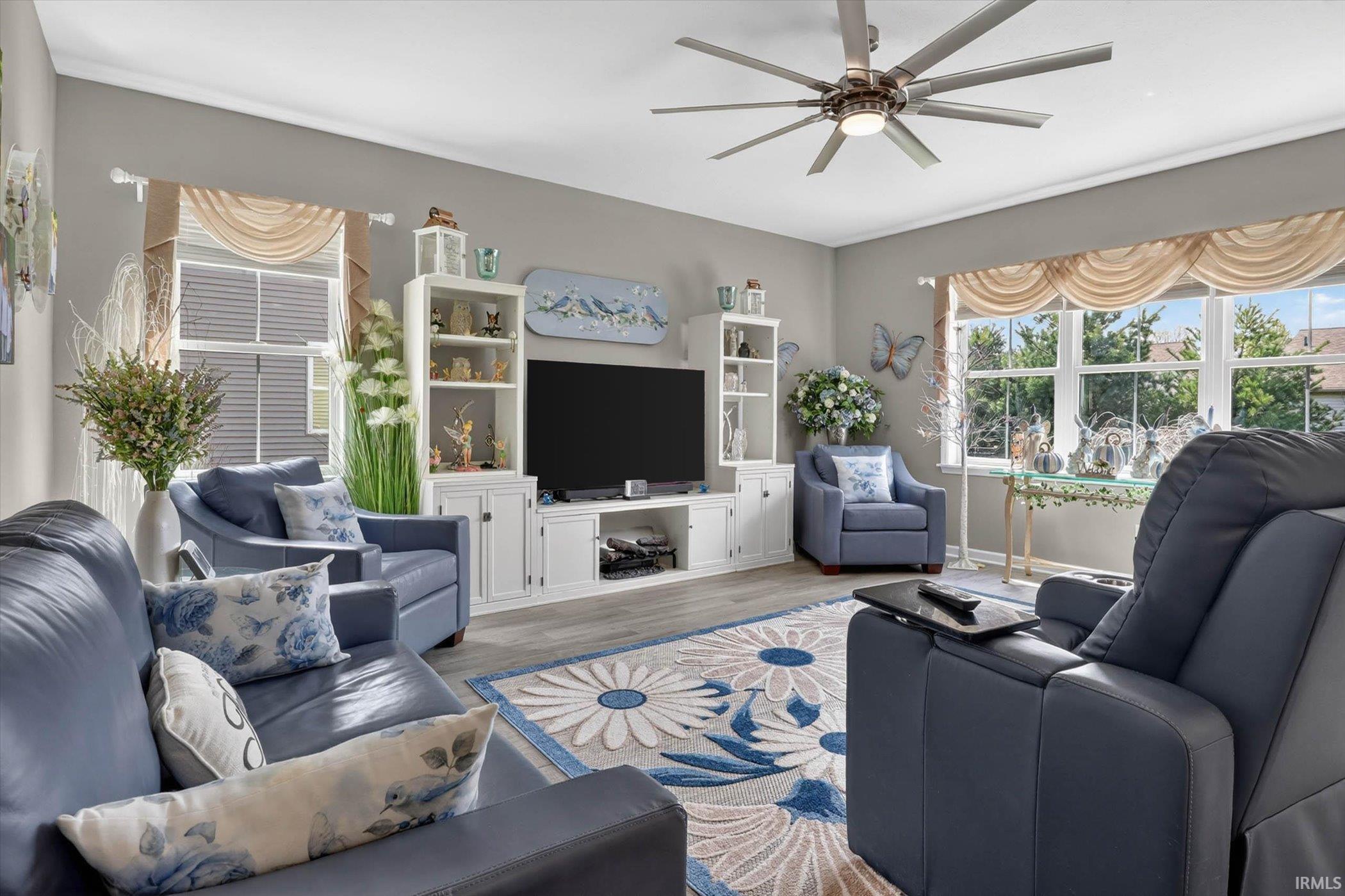 Living room featuring wood finished floors and ceiling fan