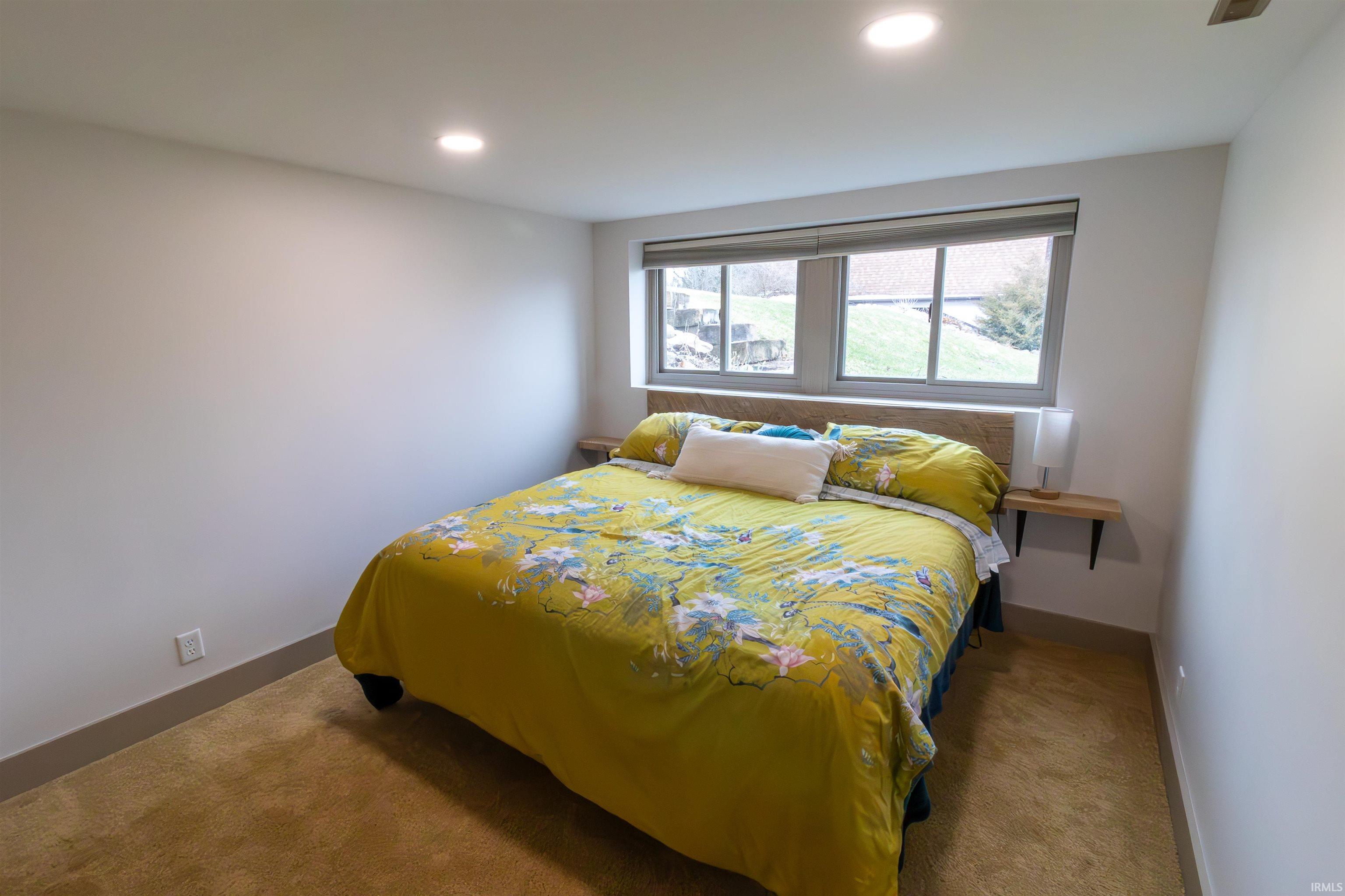 Carpeted bedroom featuring baseboards and recessed lighting