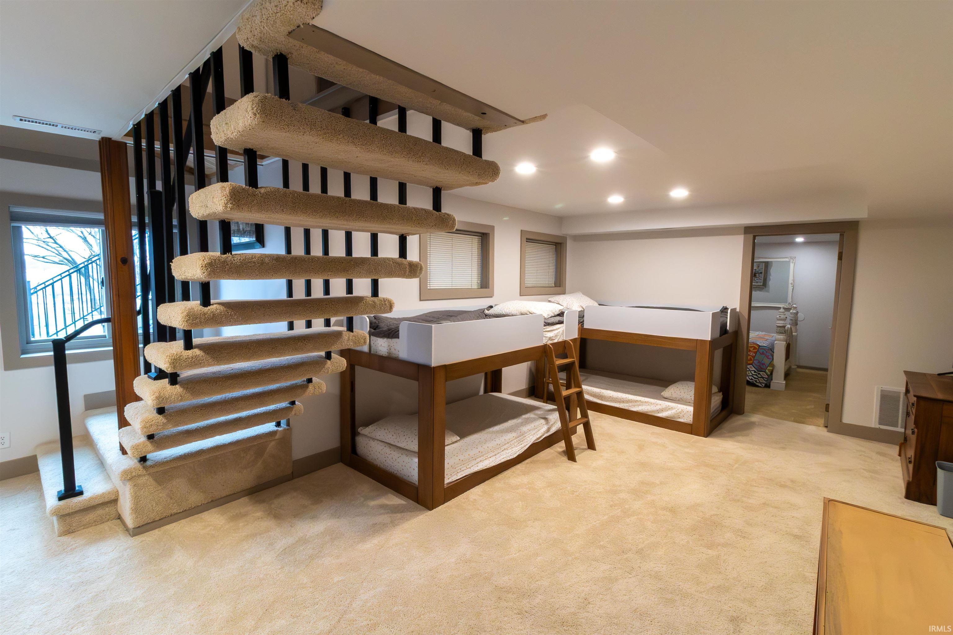 Staircase featuring carpet and recessed lighting