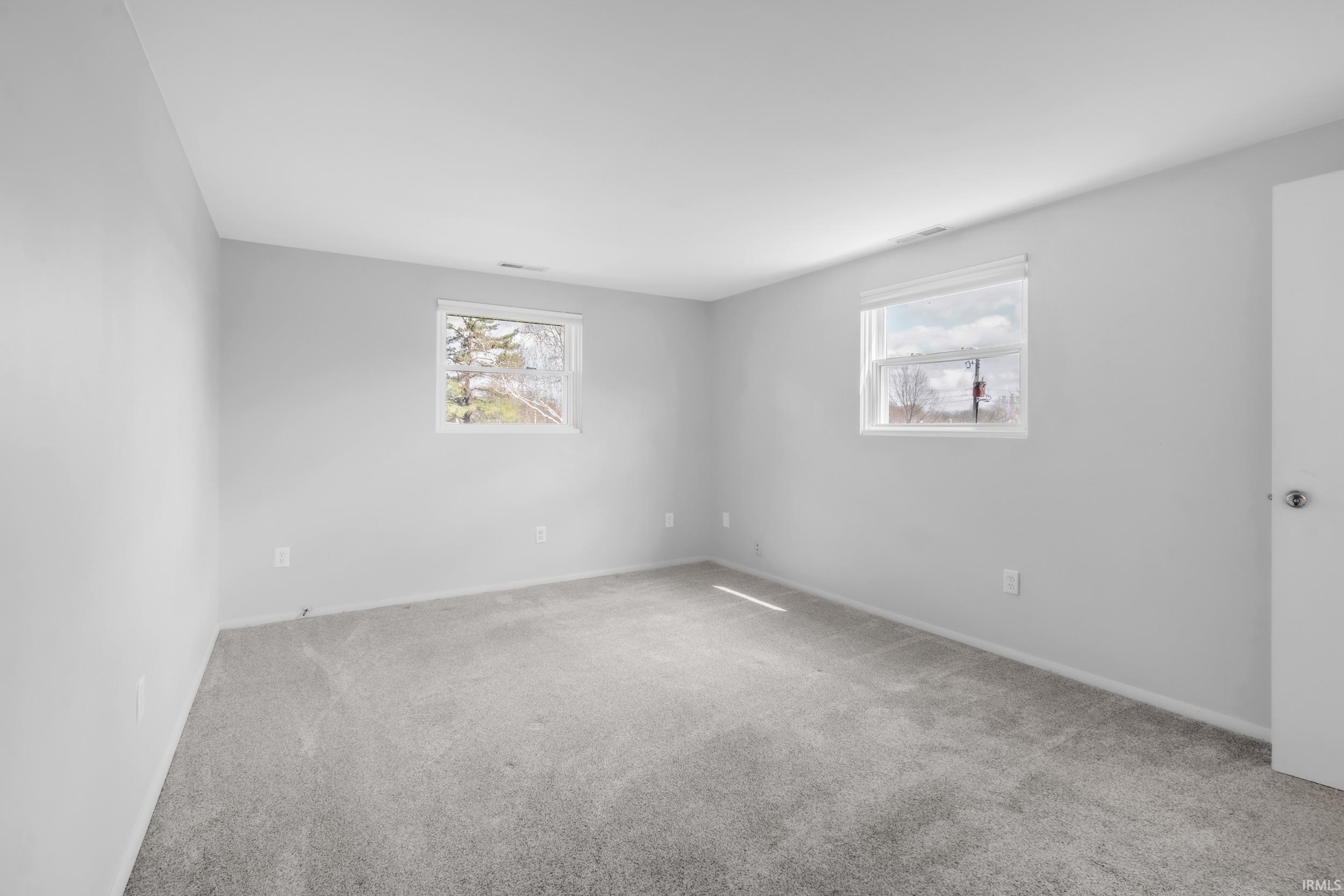 Unfurnished room with carpet and baseboards
