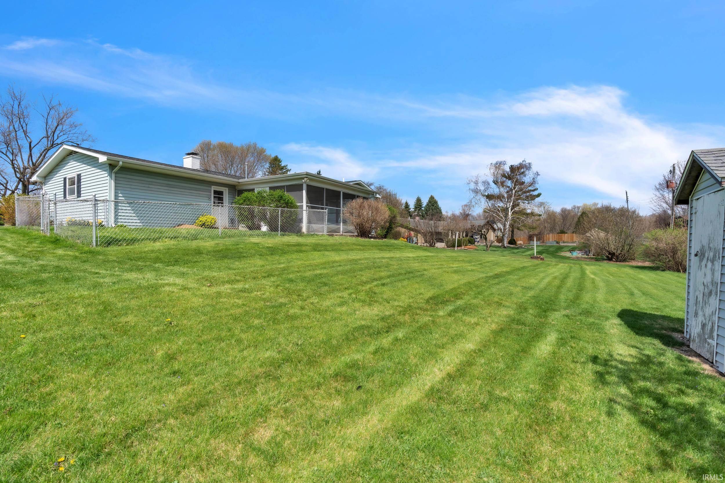 View of yard with a sunroom