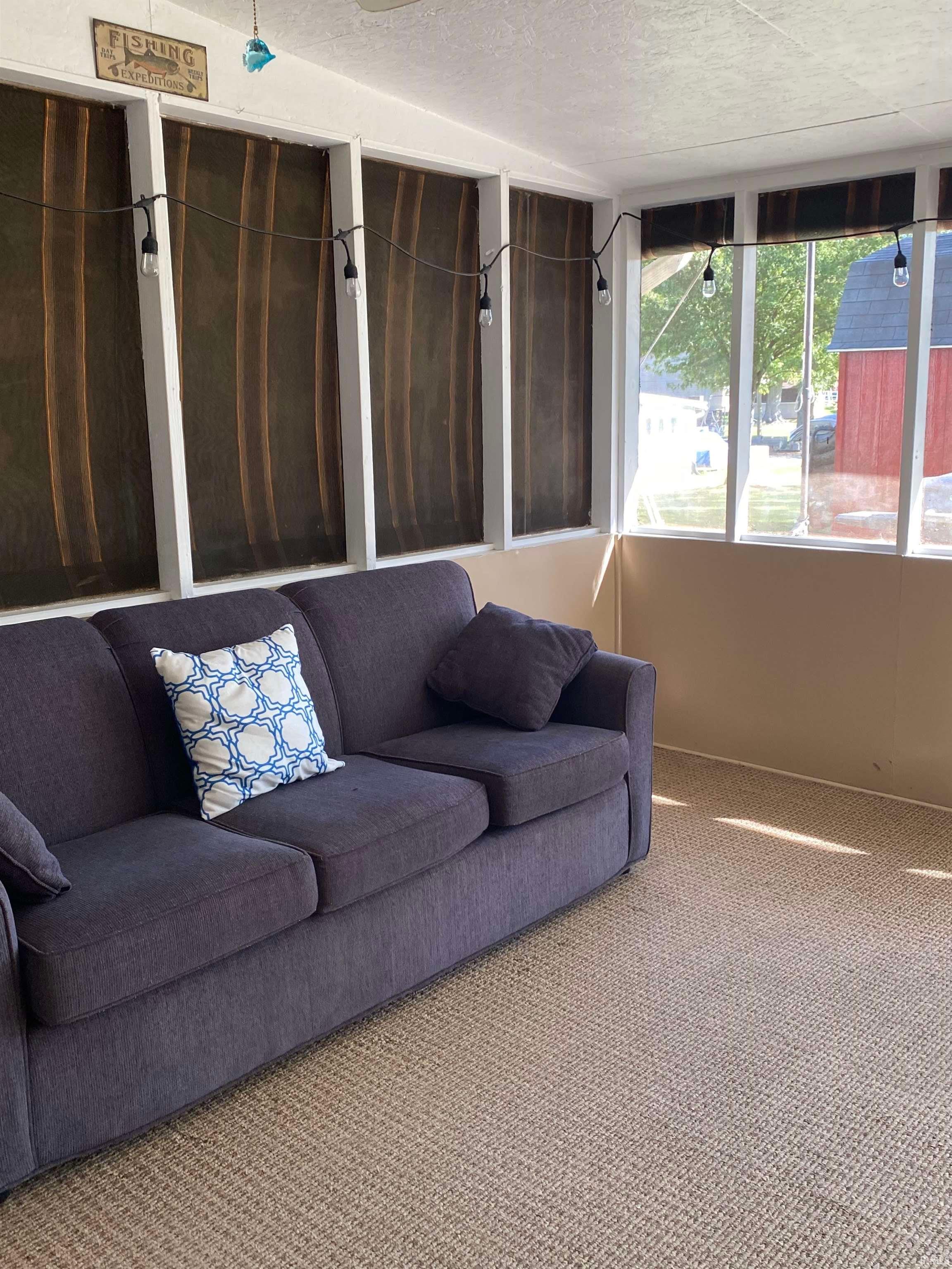 Unfurnished living room featuring wallpapered walls