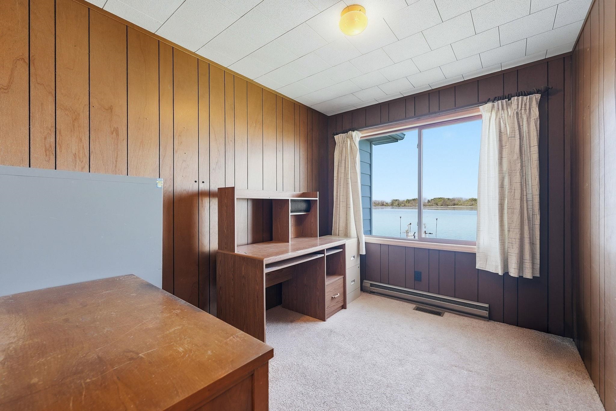 Expansive window overlooking a body of water, providing natural light