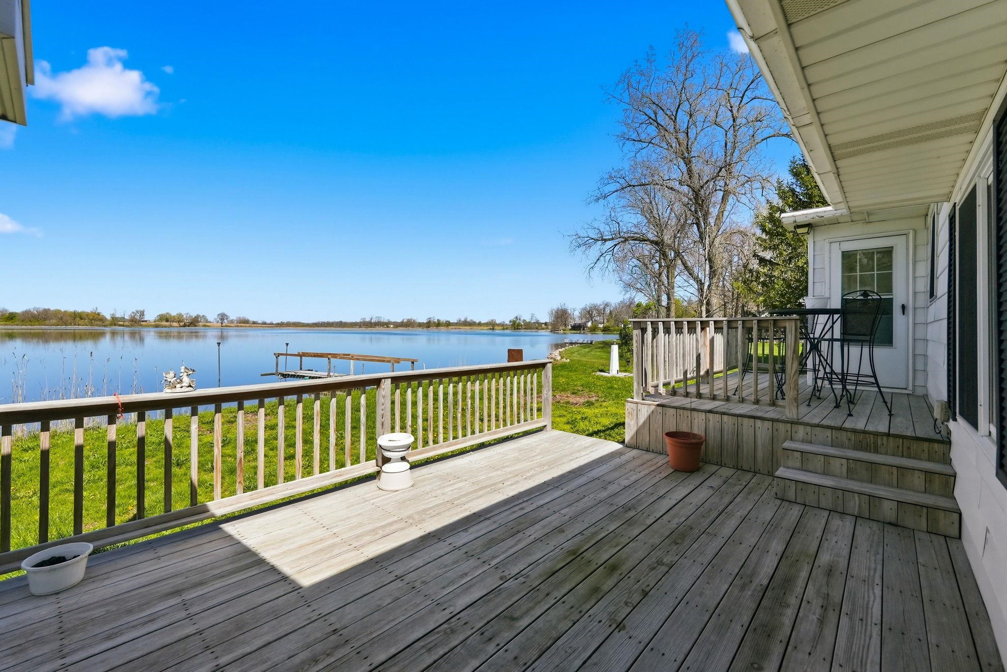 Spacious wood deck offering direct waterfront access with a private dock