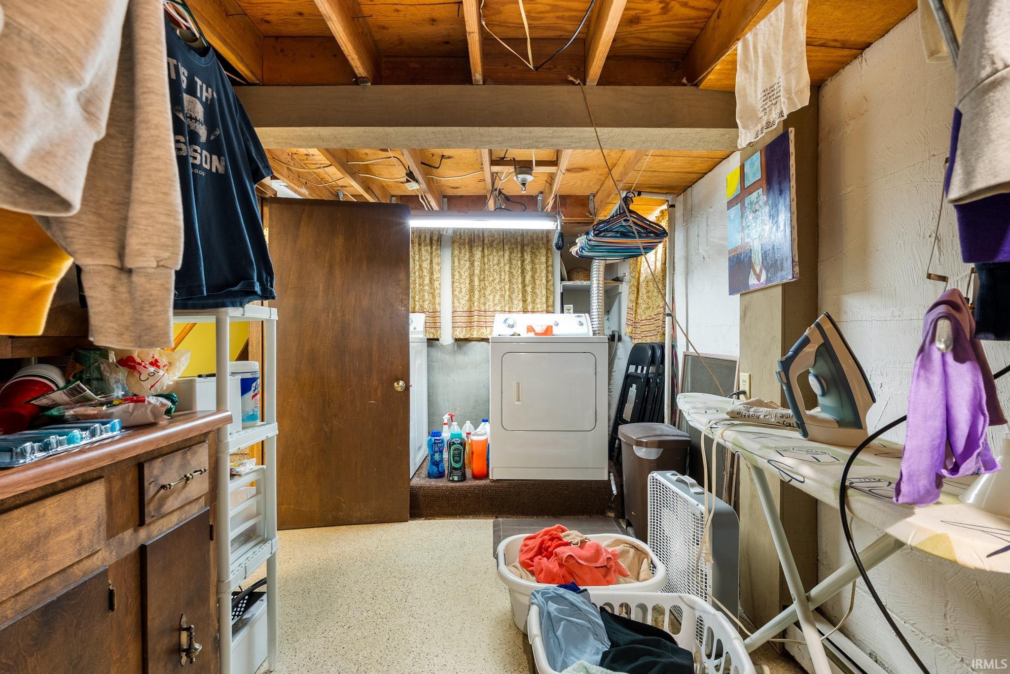 Laundry area with dark aggregate flooring