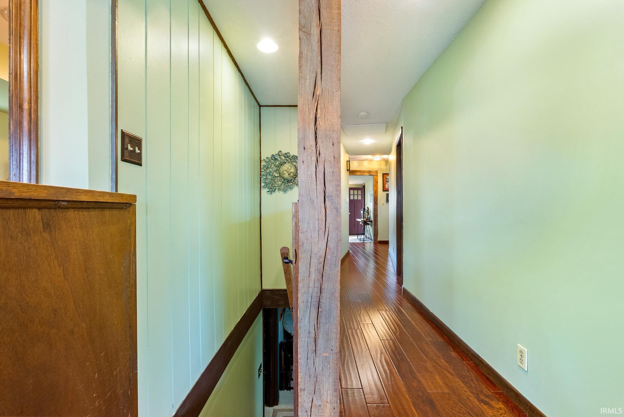 Hall featuring dark wood-style flooring and recessed lighting