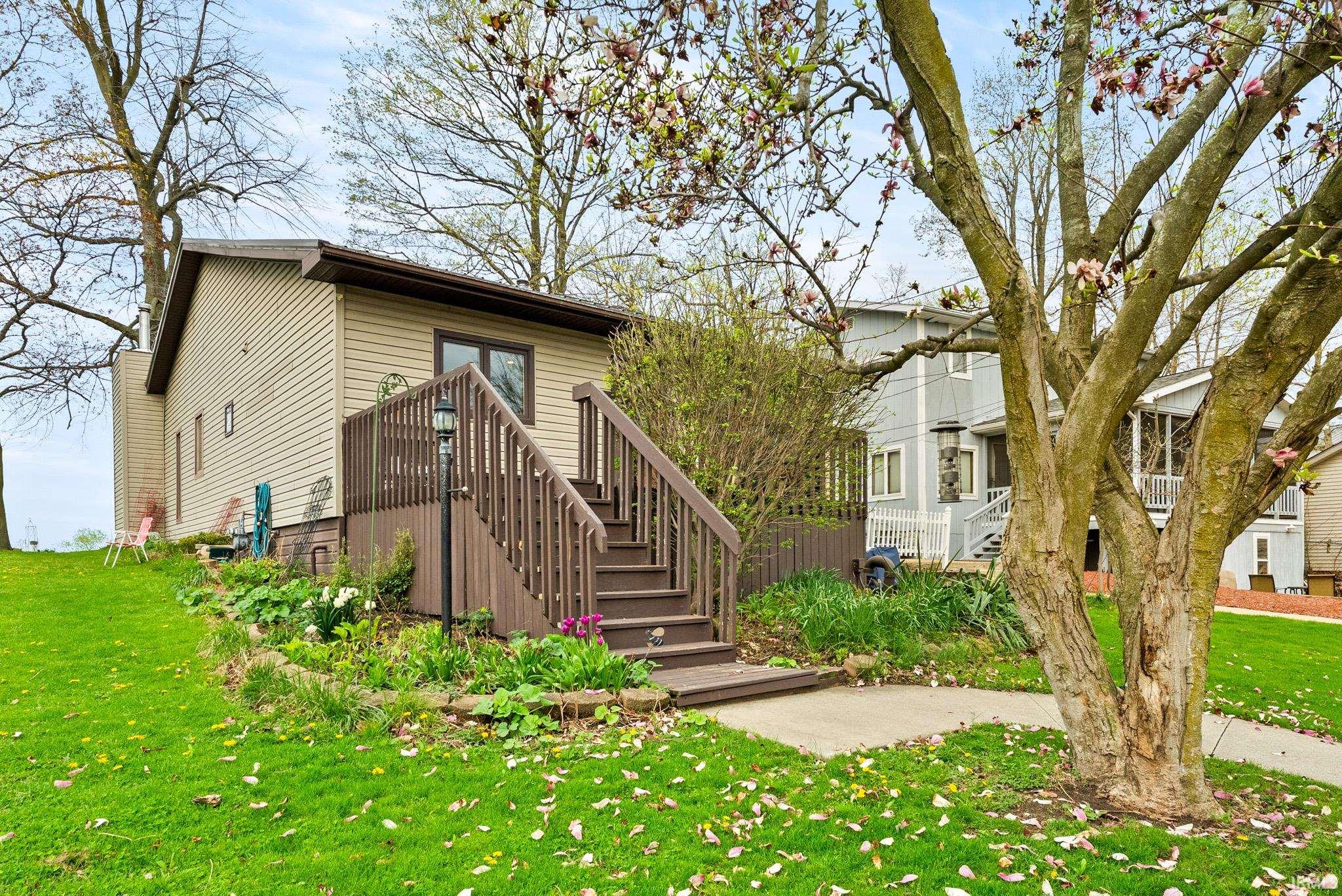 View of front facade featuring a front yard and stairs