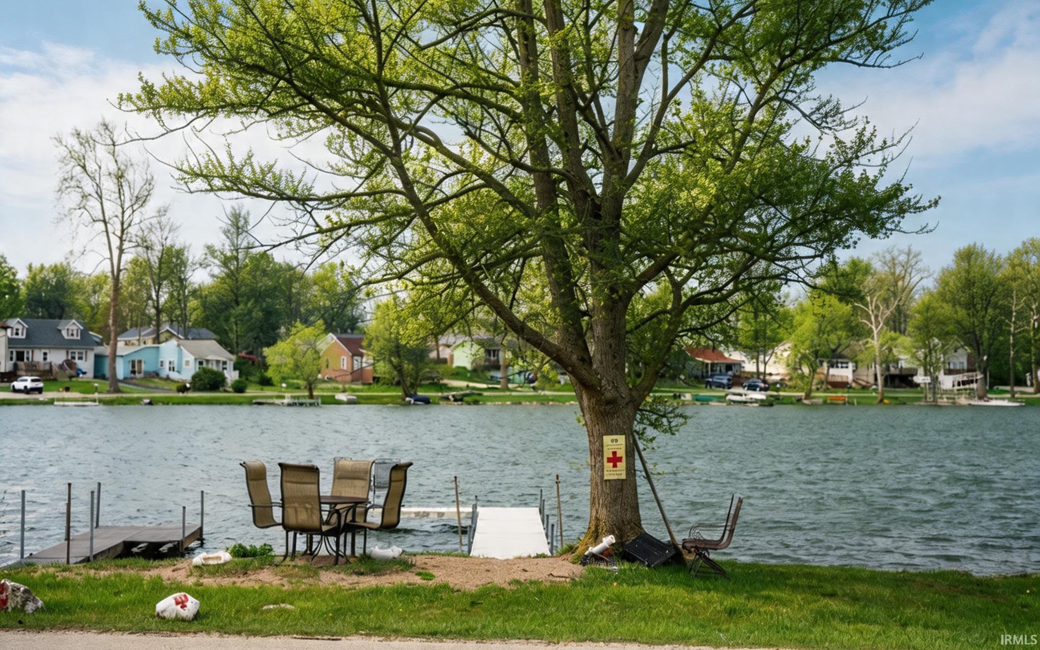 Dock area with a water view and a residential view