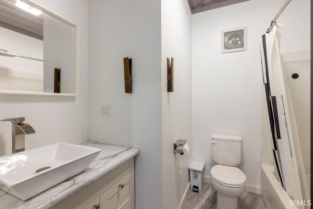 Full bathroom with vanity and shower / tub combo with curtain