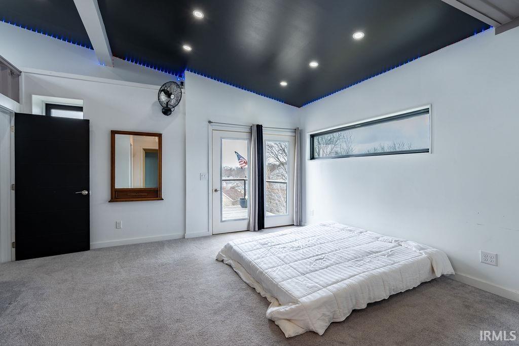 Carpeted bedroom featuring lofted ceiling, access to exterior, and recessed lighting