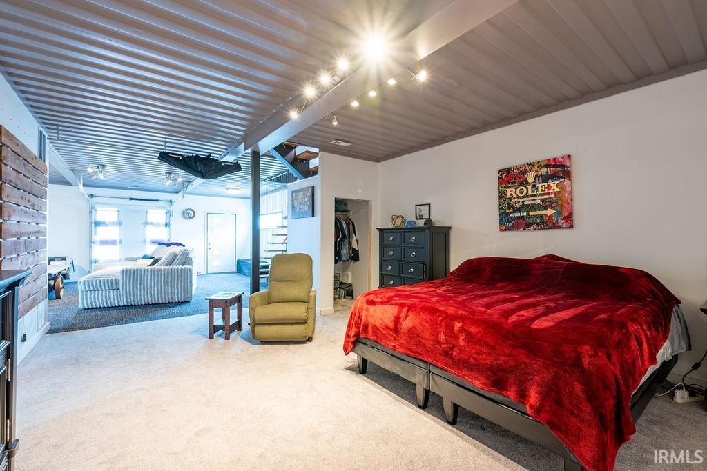 Bedroom featuring carpet floors and a spacious closet