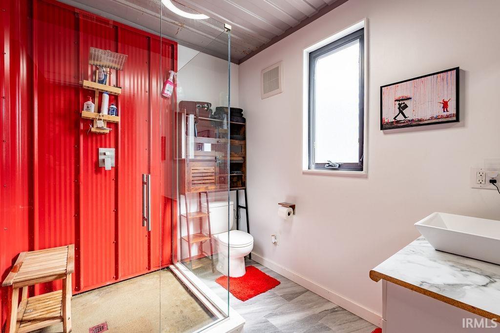 Bathroom with a shower stall and vanity