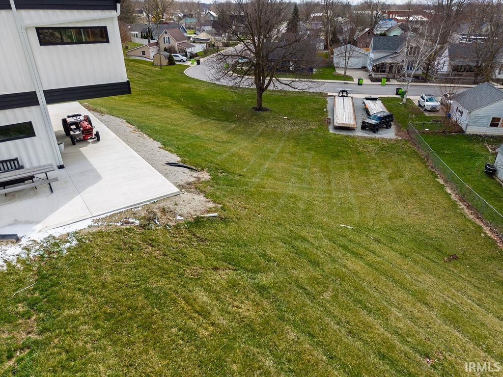 View of grassy yard featuring a residential view and a patio