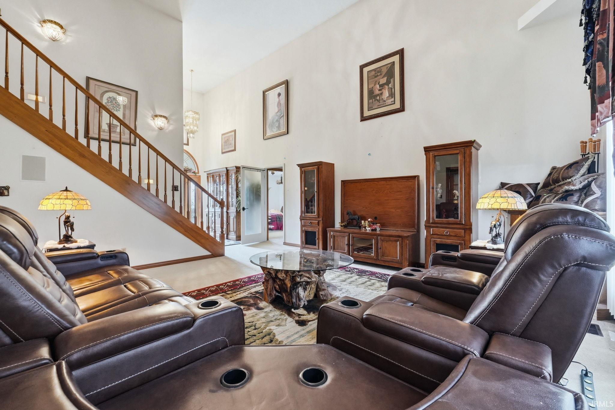 Living room featuring a high ceiling and hanging lights