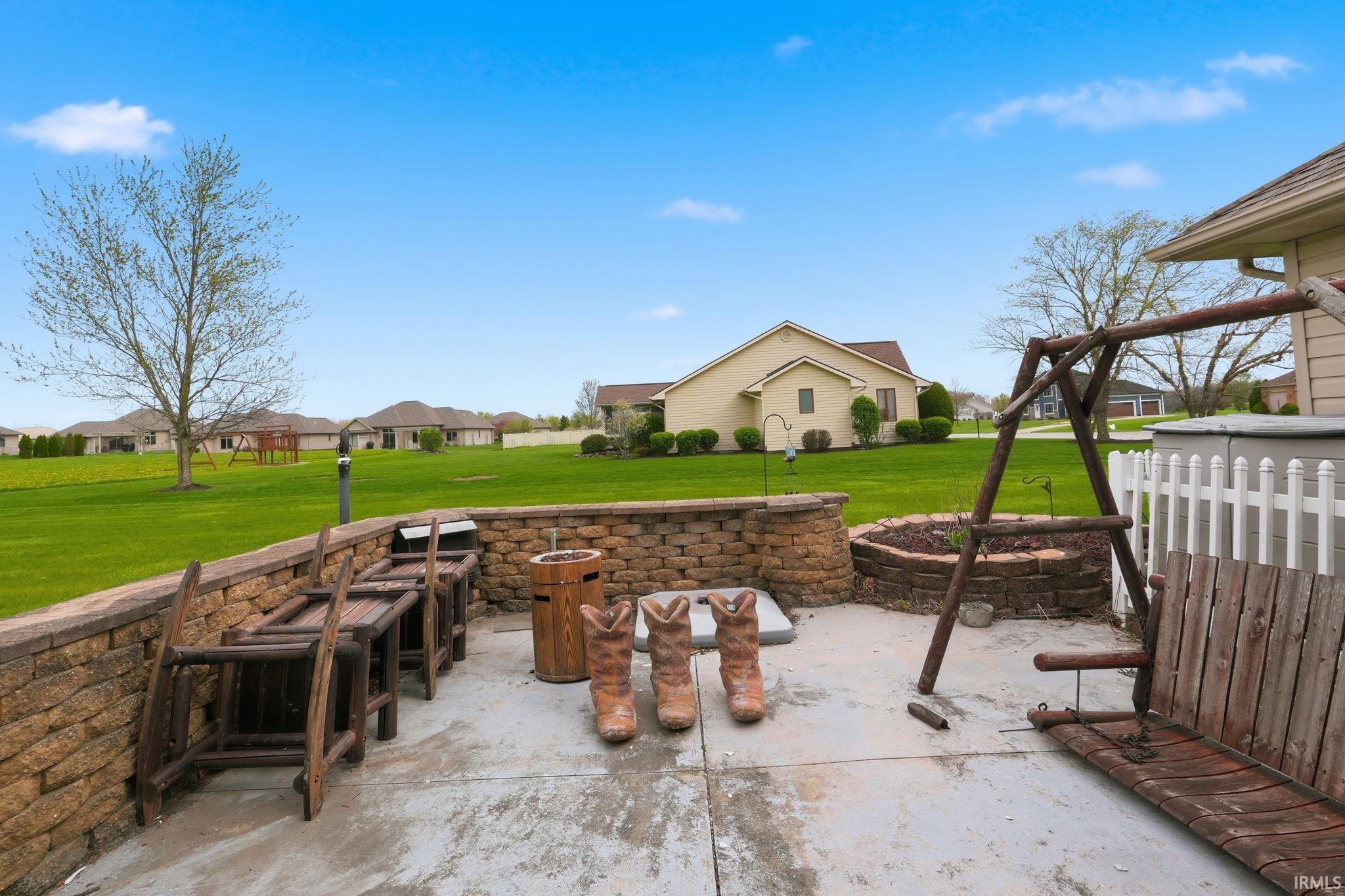 View of patio featuring an outdoor fire pit and a residential view
