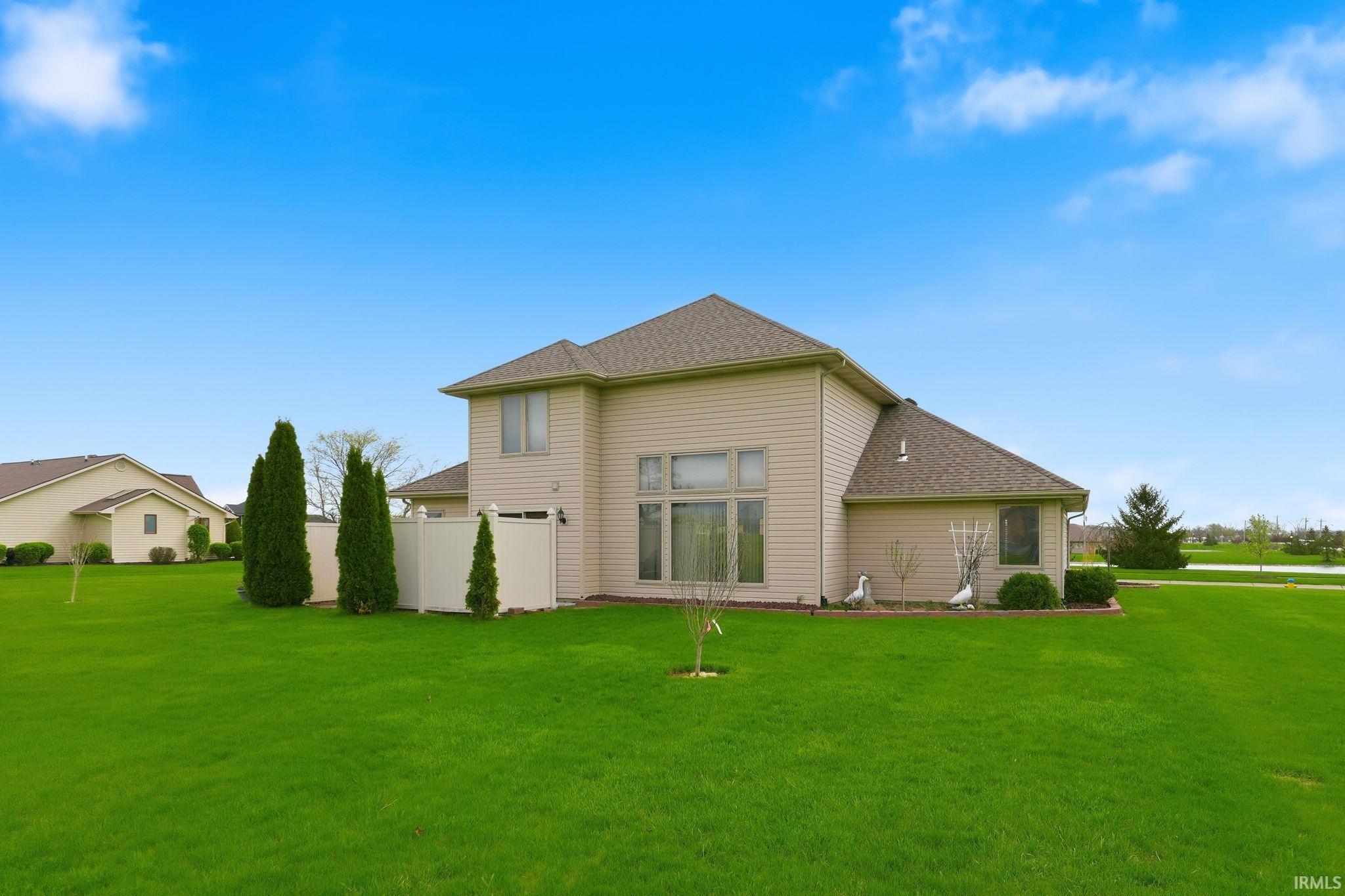 Rear view of property with roof with shingles