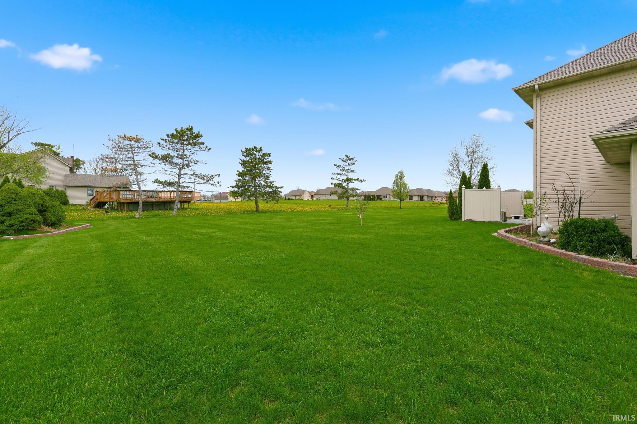 View of green lawn with a residential view