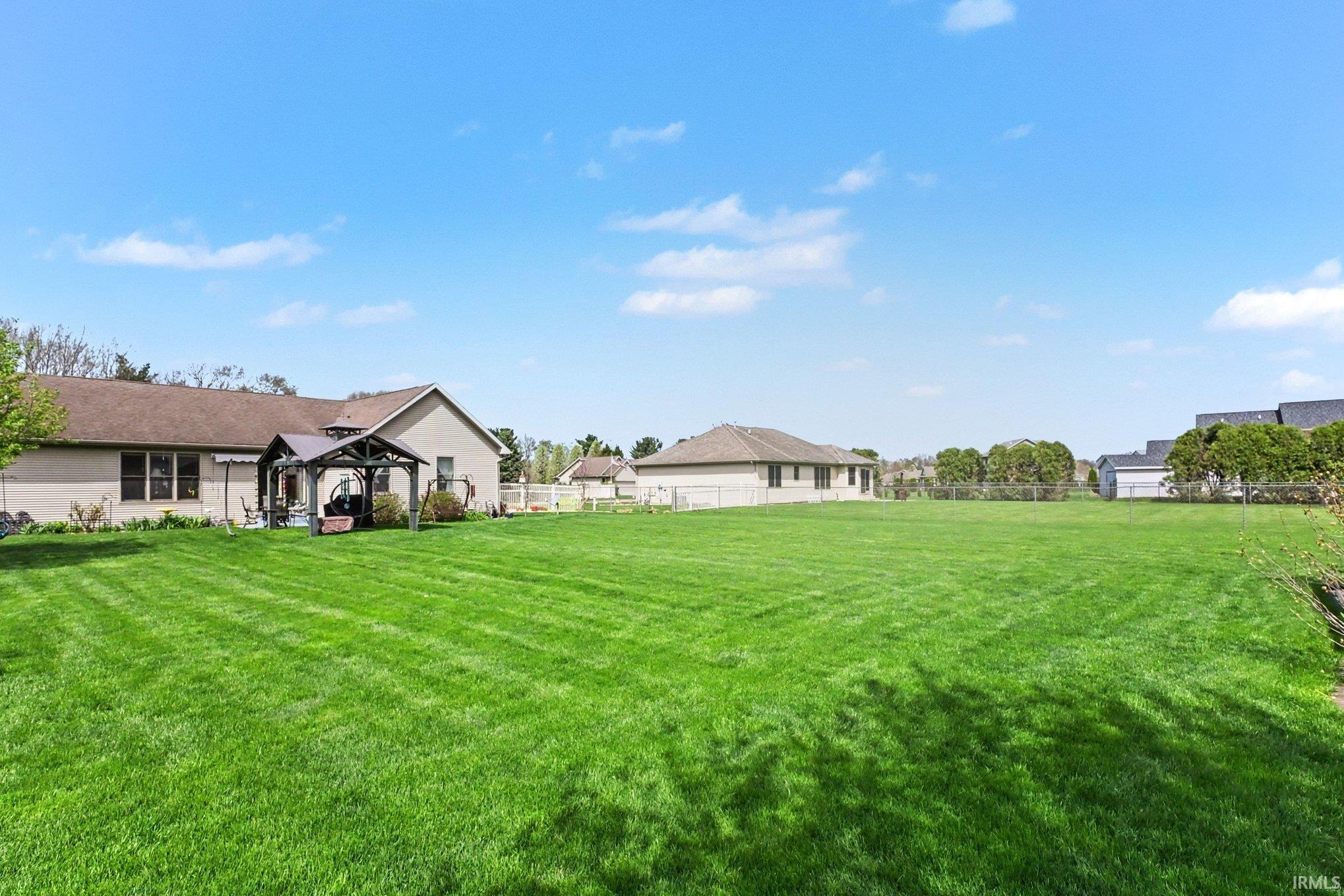 Fenced yard with a gazebo and a patio