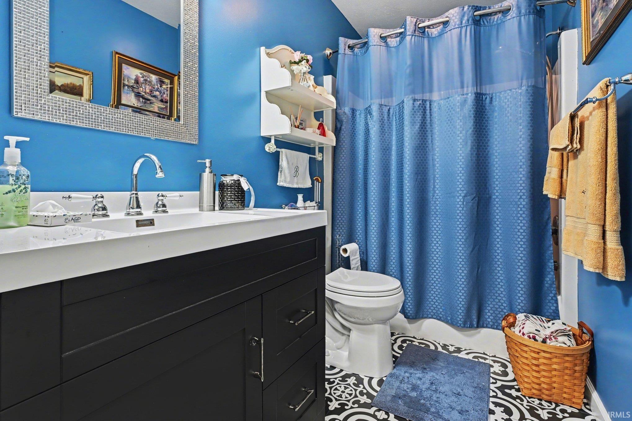 Bathroom featuring vanity and tile patterned floors