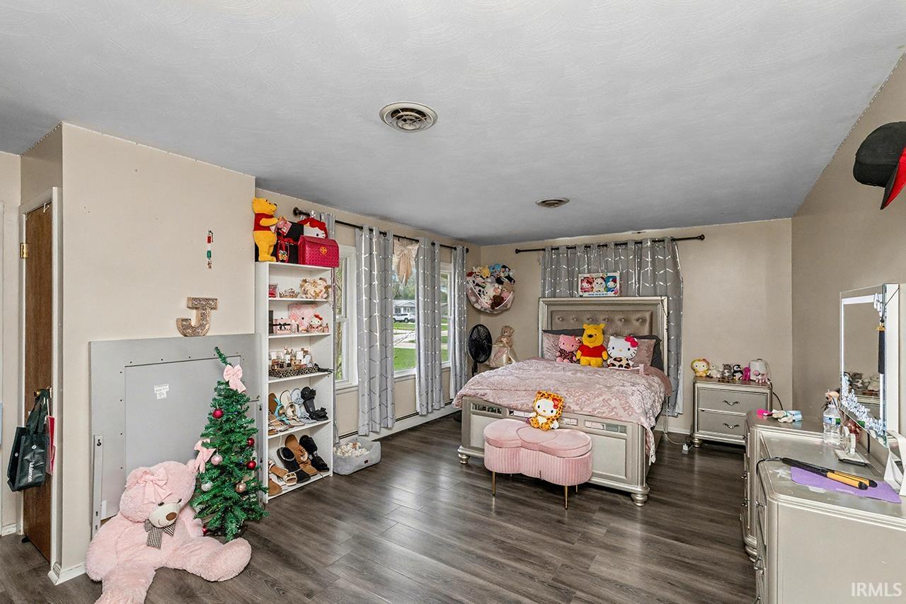Bedroom featuring dark wood-style floors