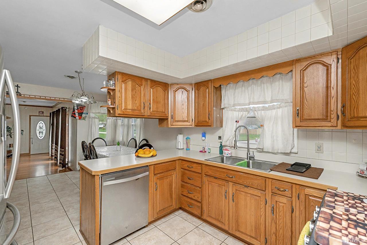 Kitchen featuring light countertops, wood finish cabinetry, and stainless steel appliances