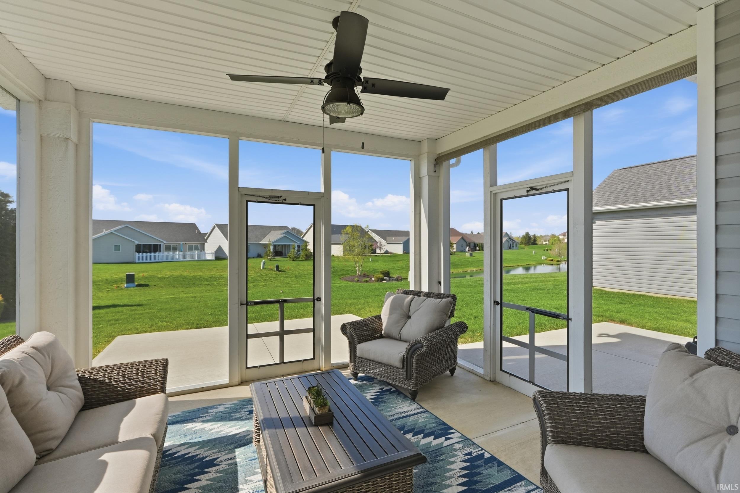 Sunroom / solarium with an outdoor hangout area, ceiling fan, a residential view, and a water view