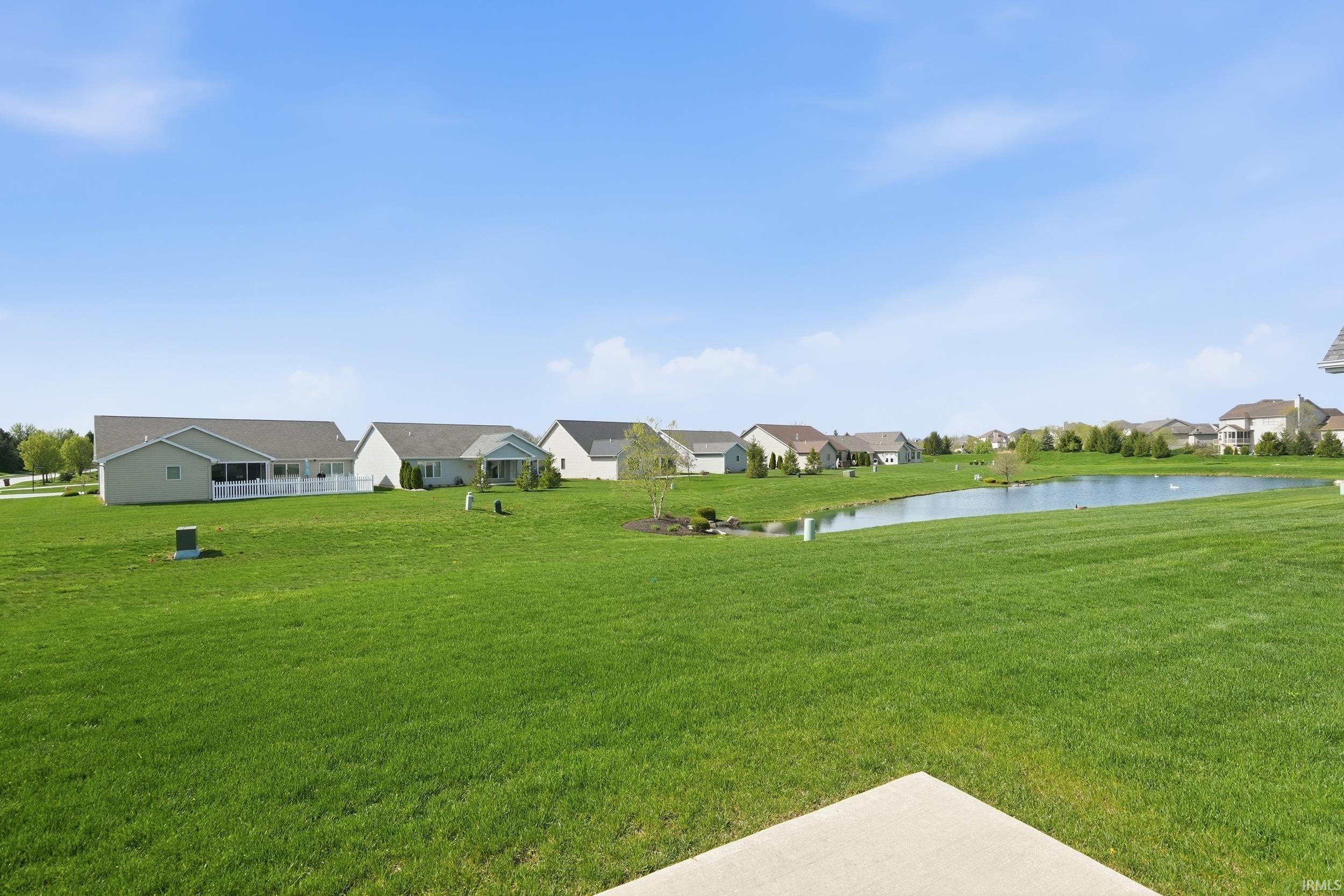 View of green lawn featuring a water view and a residential view