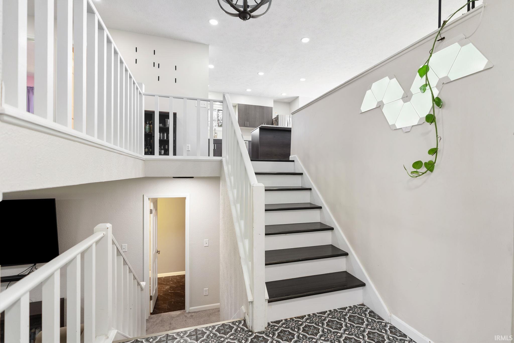 Staircase featuring recessed lighting and baseboards