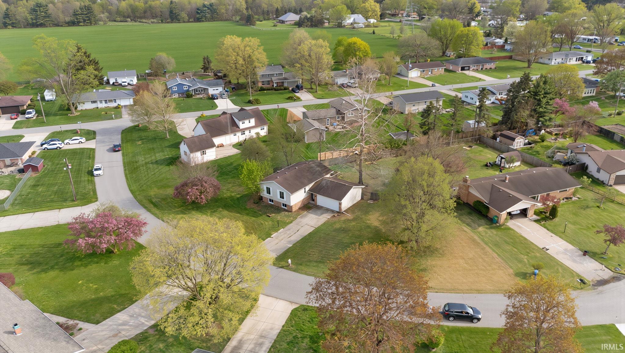 Aerial perspective of suburban area featuring a golf club