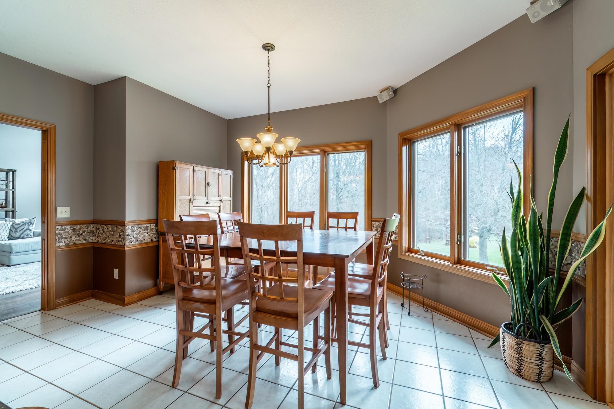 Dining area featuring suspended lighting and light tile patterned floors