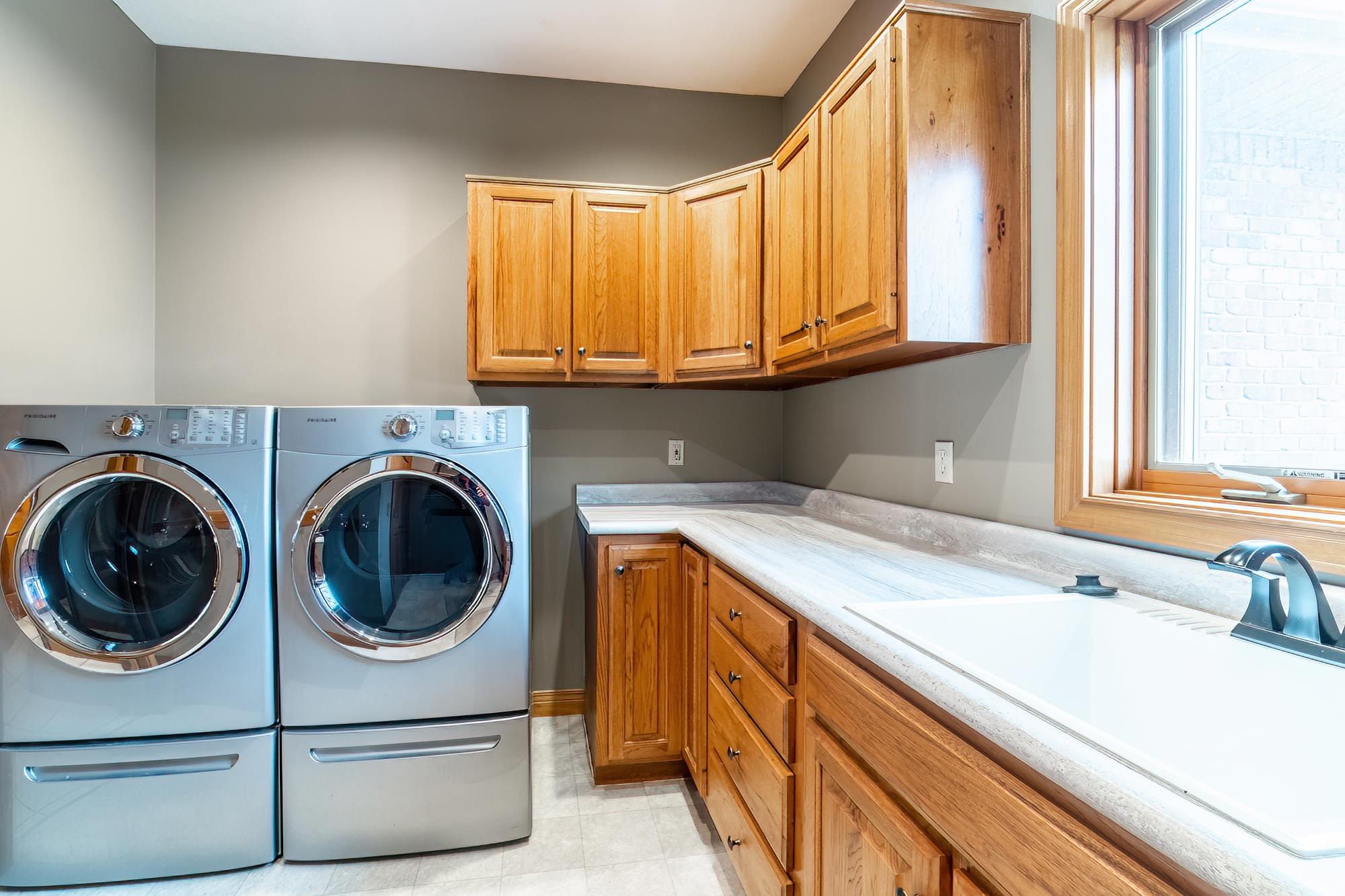 Laundry room with cabinet space and washing machine and clothes dryer
