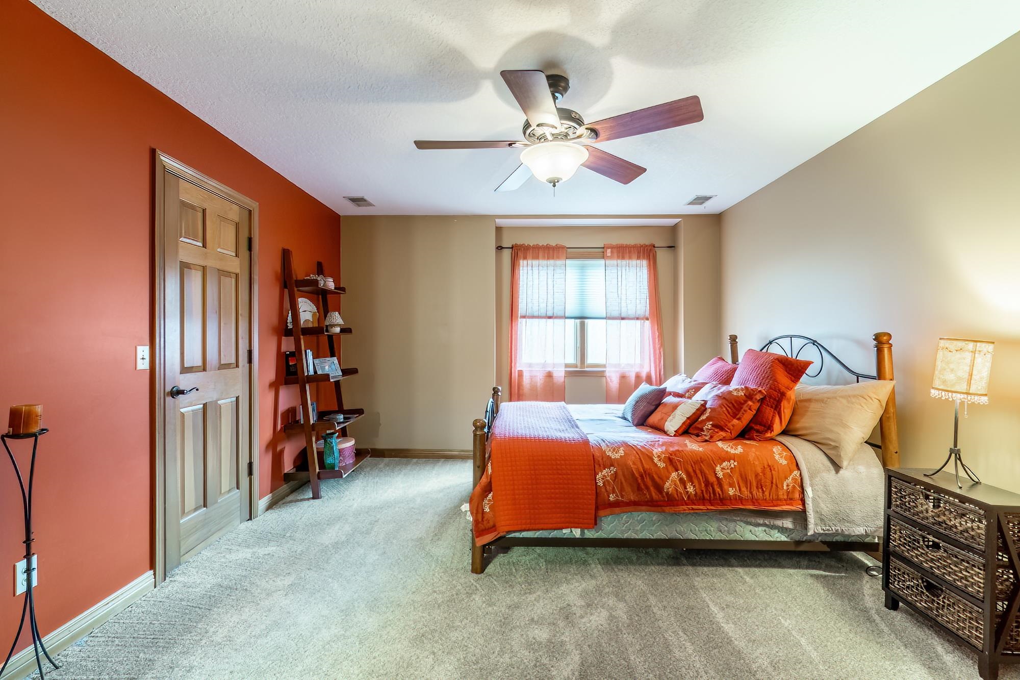 Bedroom featuring ceiling fan and carpet floors
