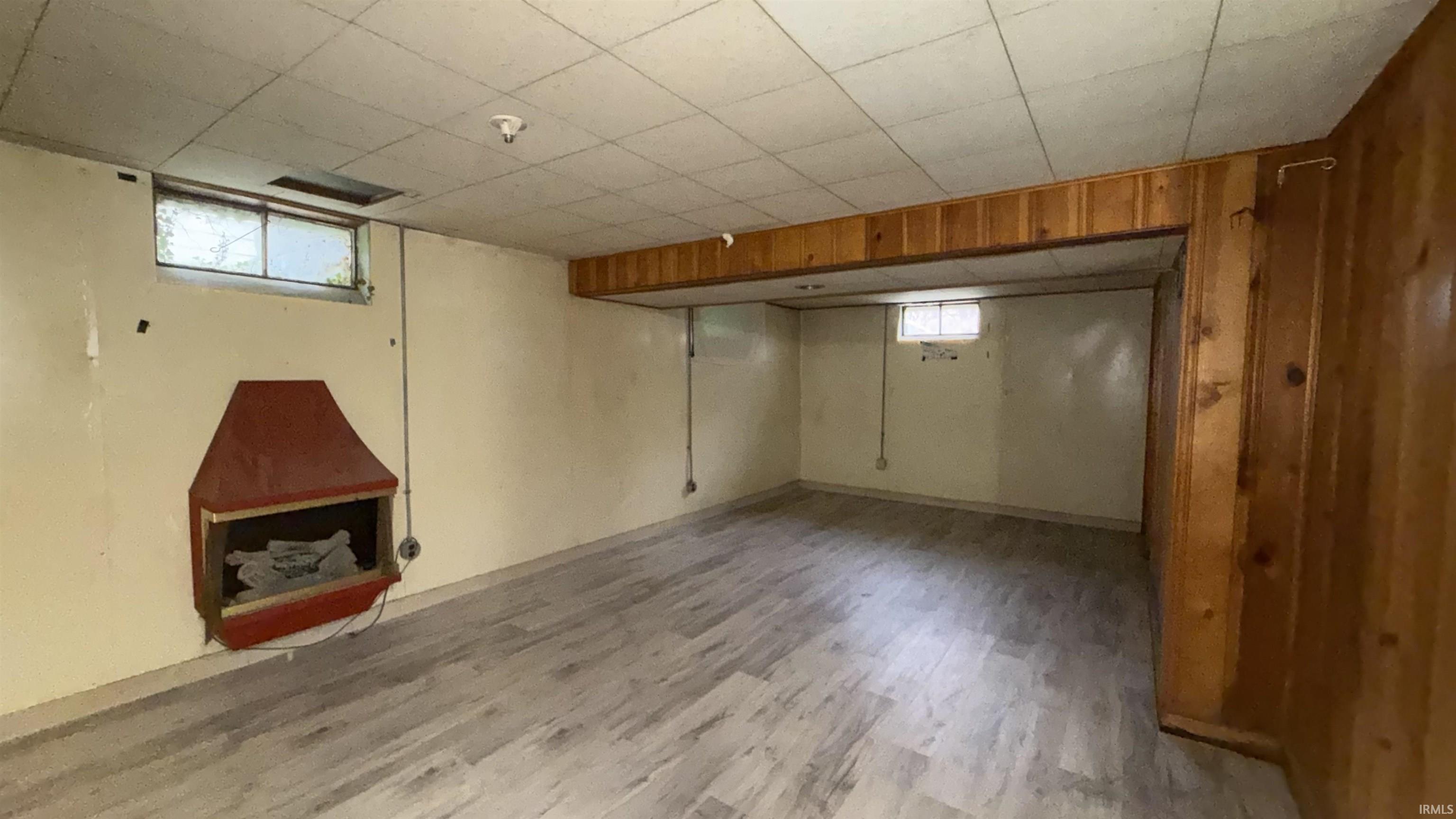 Below grade area with light wood-style flooring