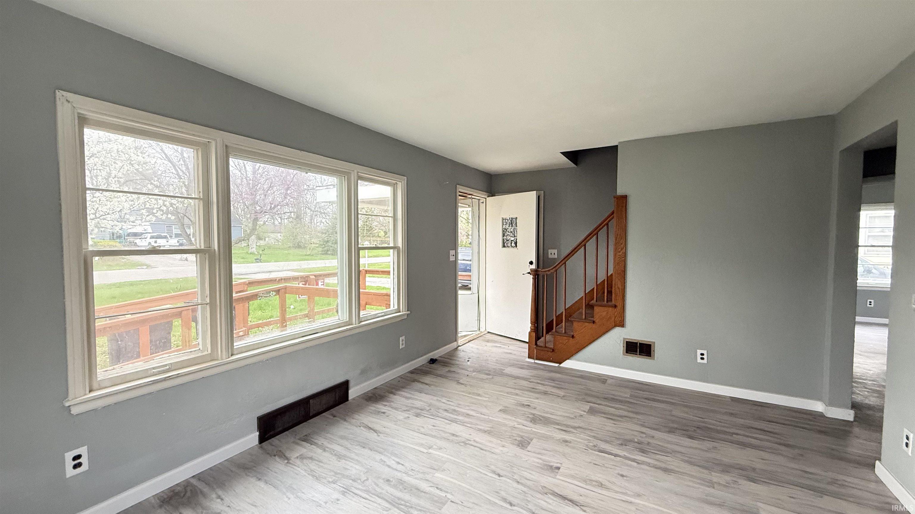 Foyer entrance with stairs and light wood-style flooring