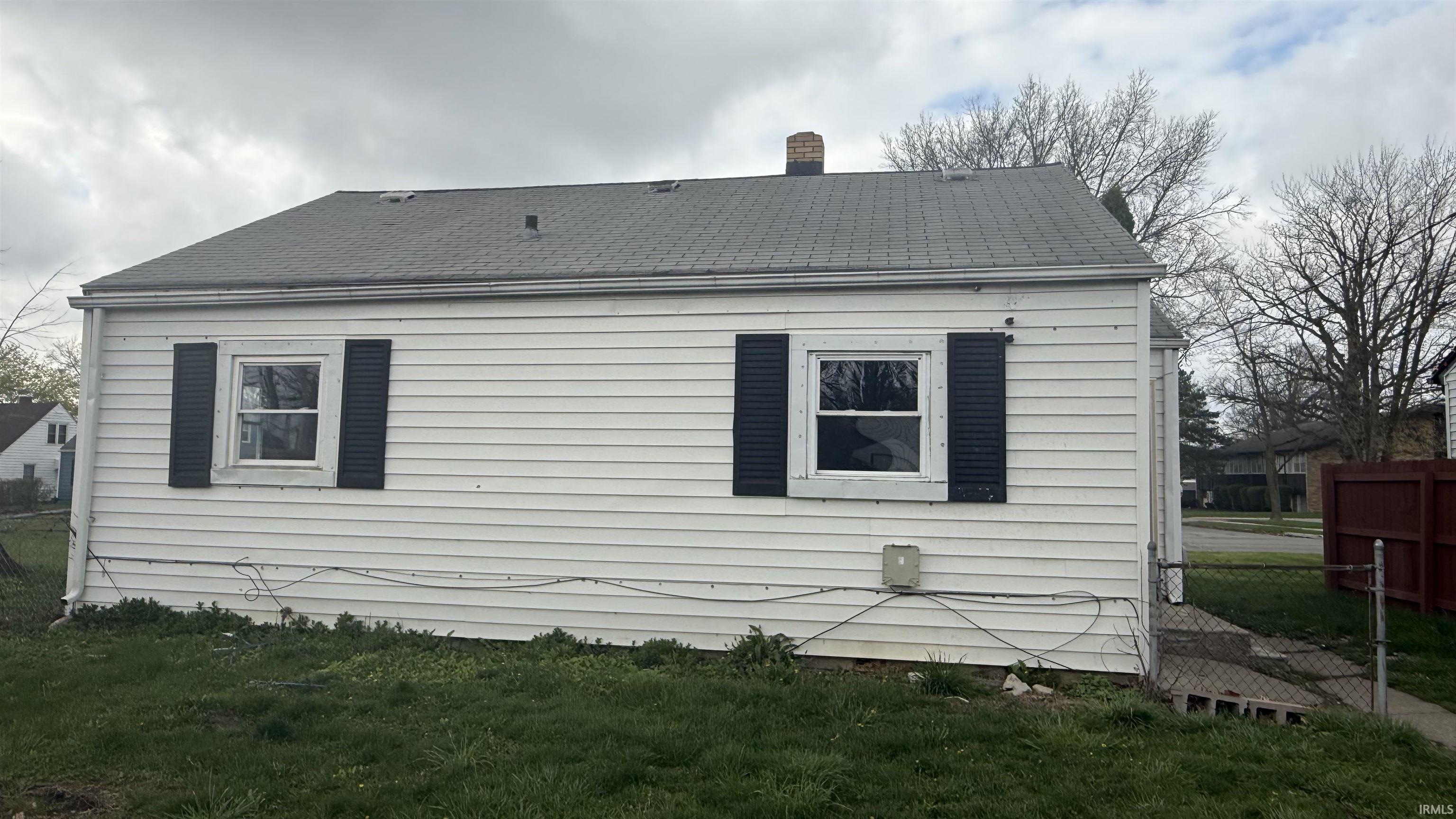 View of side of home featuring a shingled roof