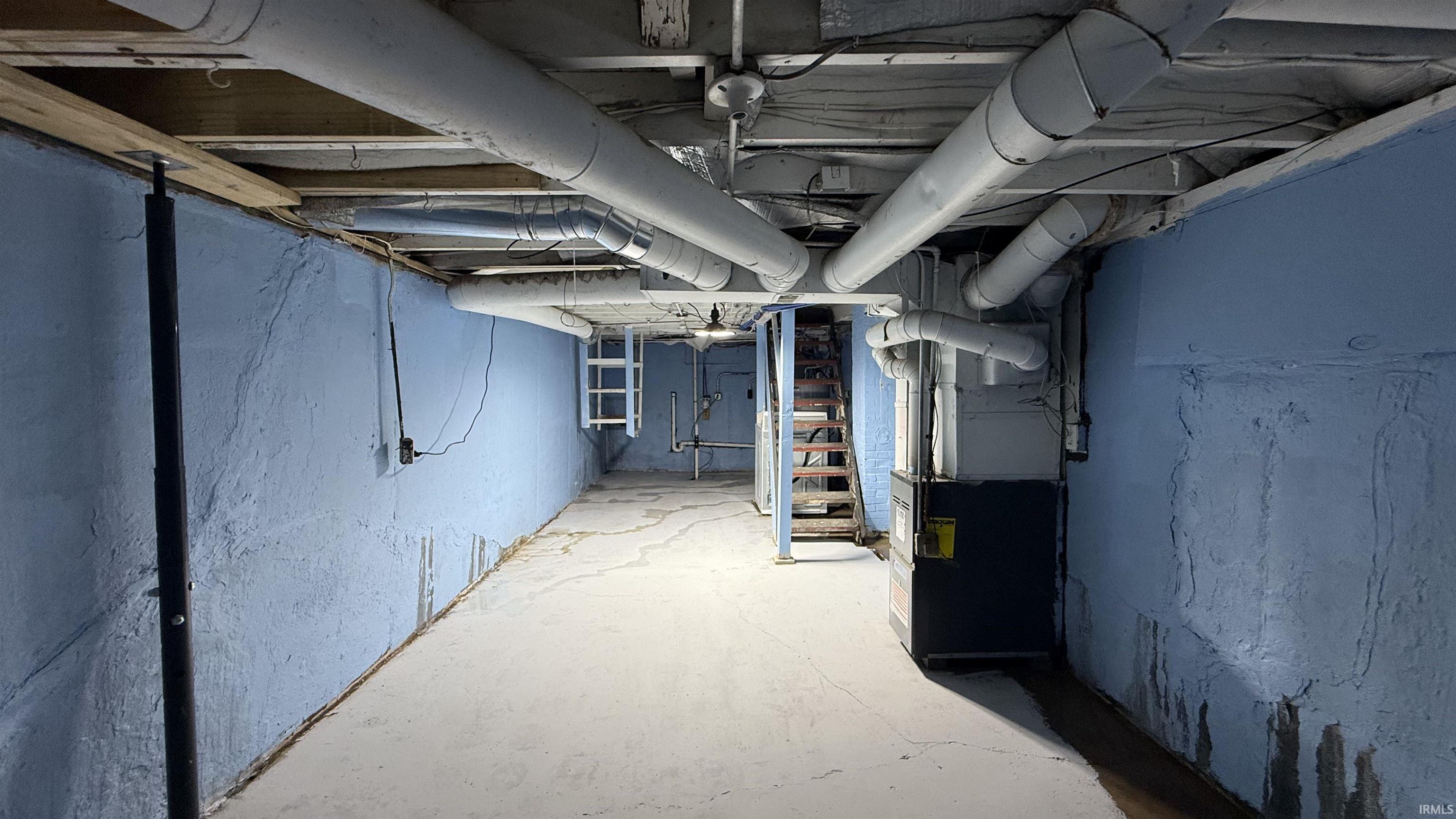 Unfinished basement featuring heating unit