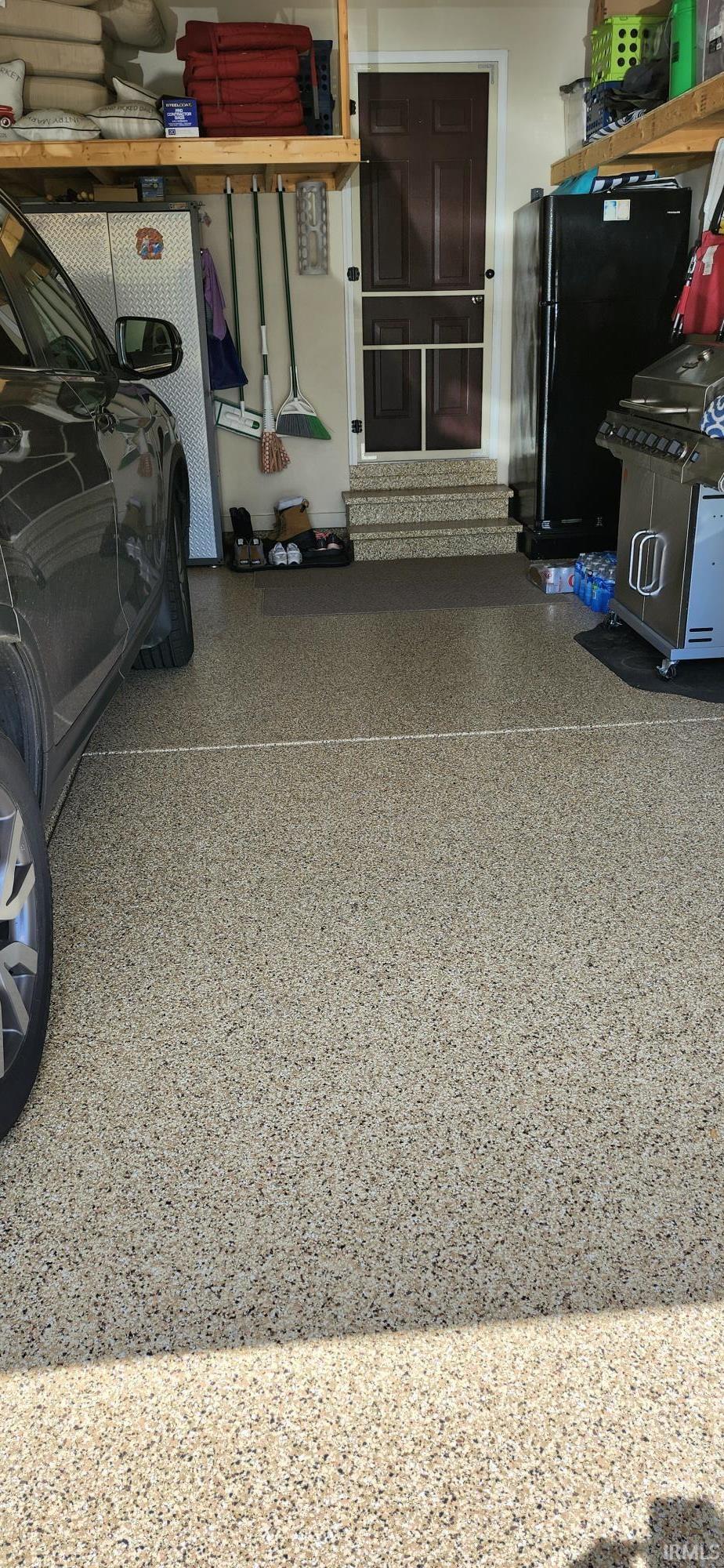 Garage featuring freestanding refrigerator
