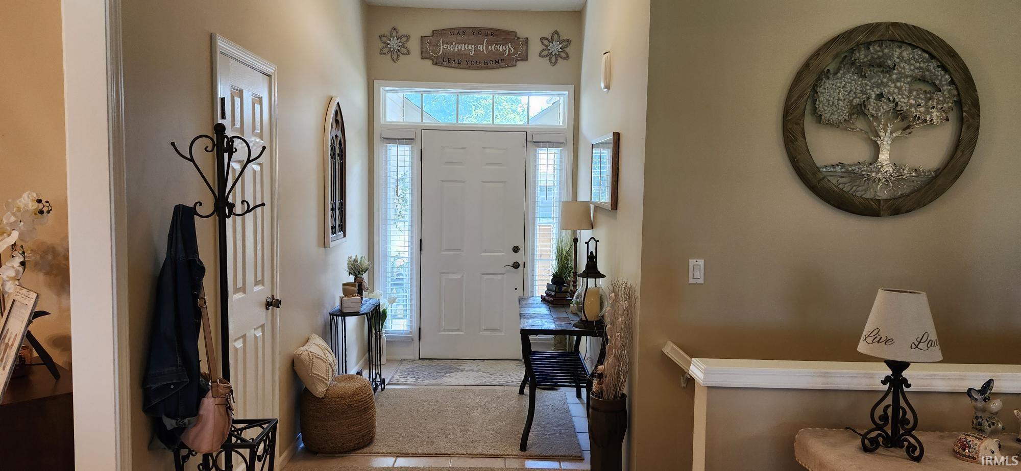 Entryway featuring light tile patterned floors