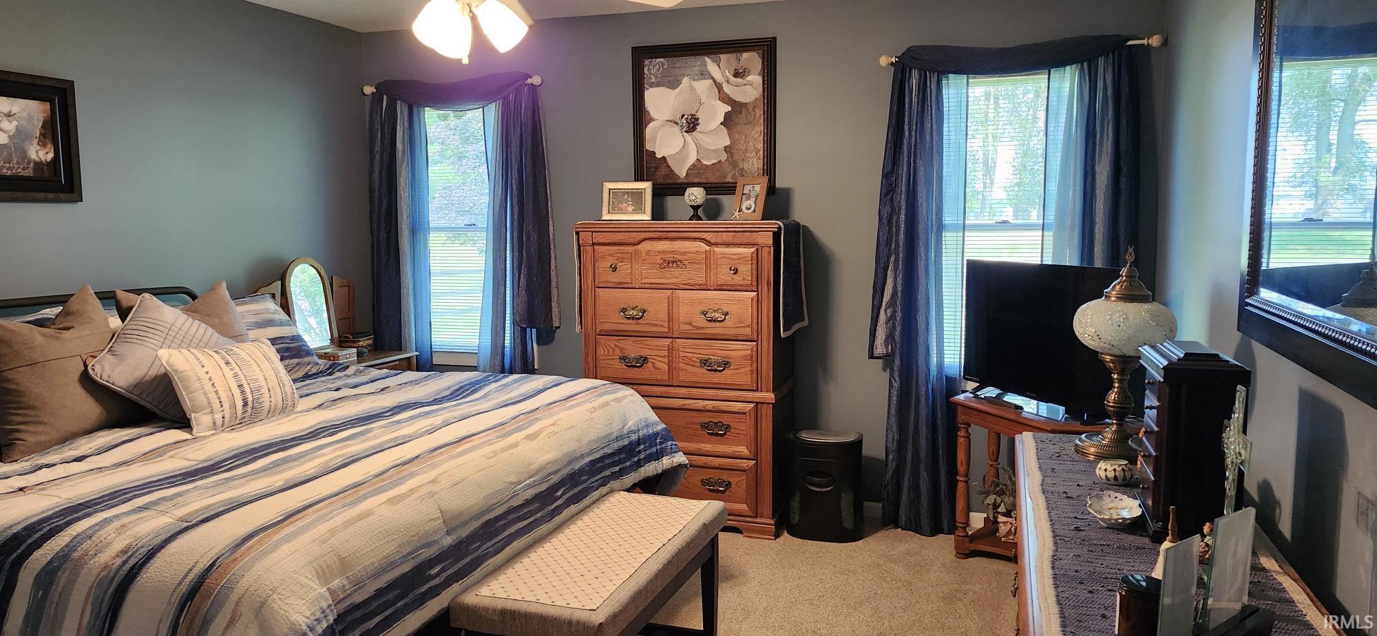 Bedroom featuring light carpet