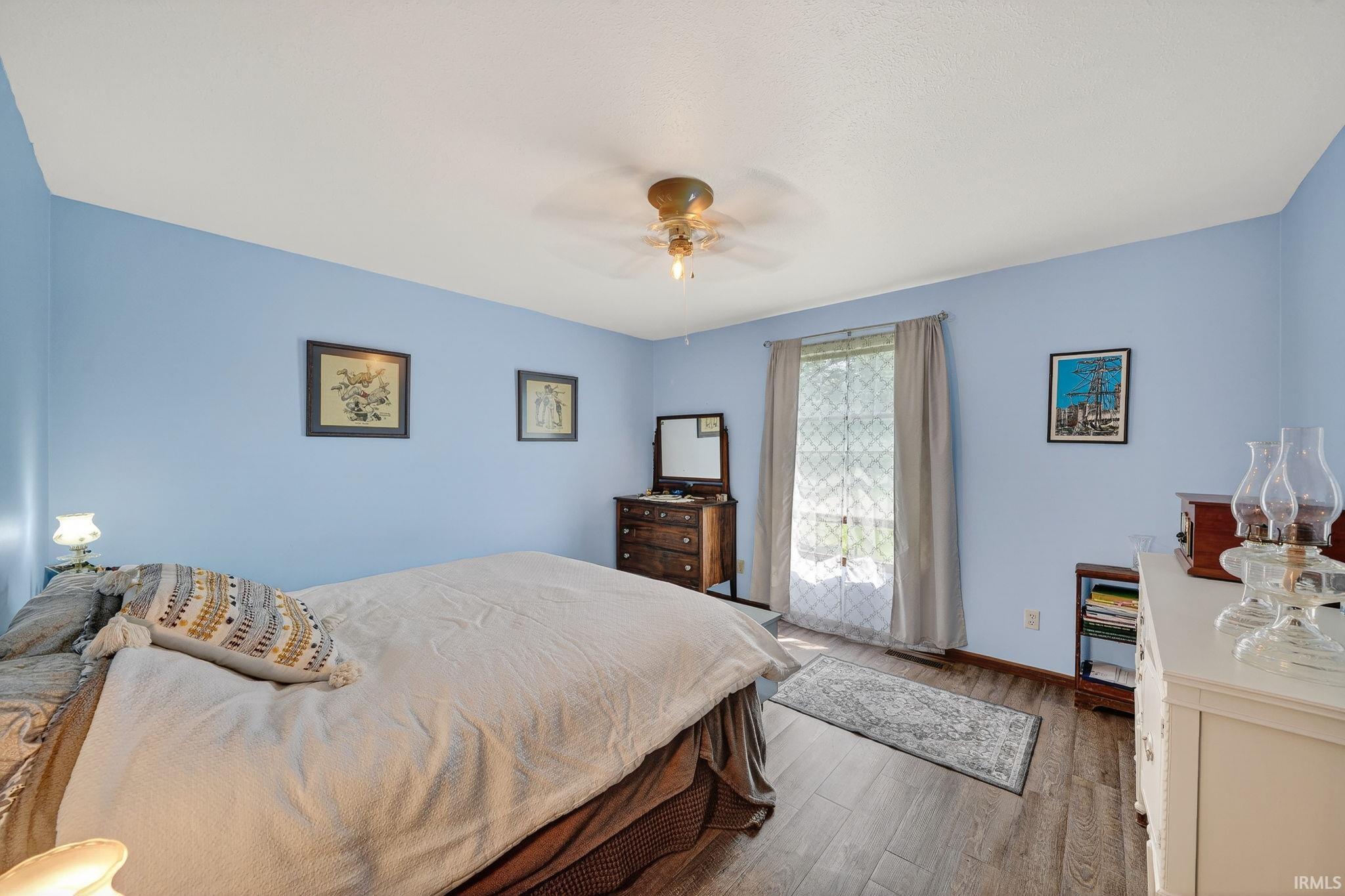 Bedroom with light wood-type flooring and ceiling fan