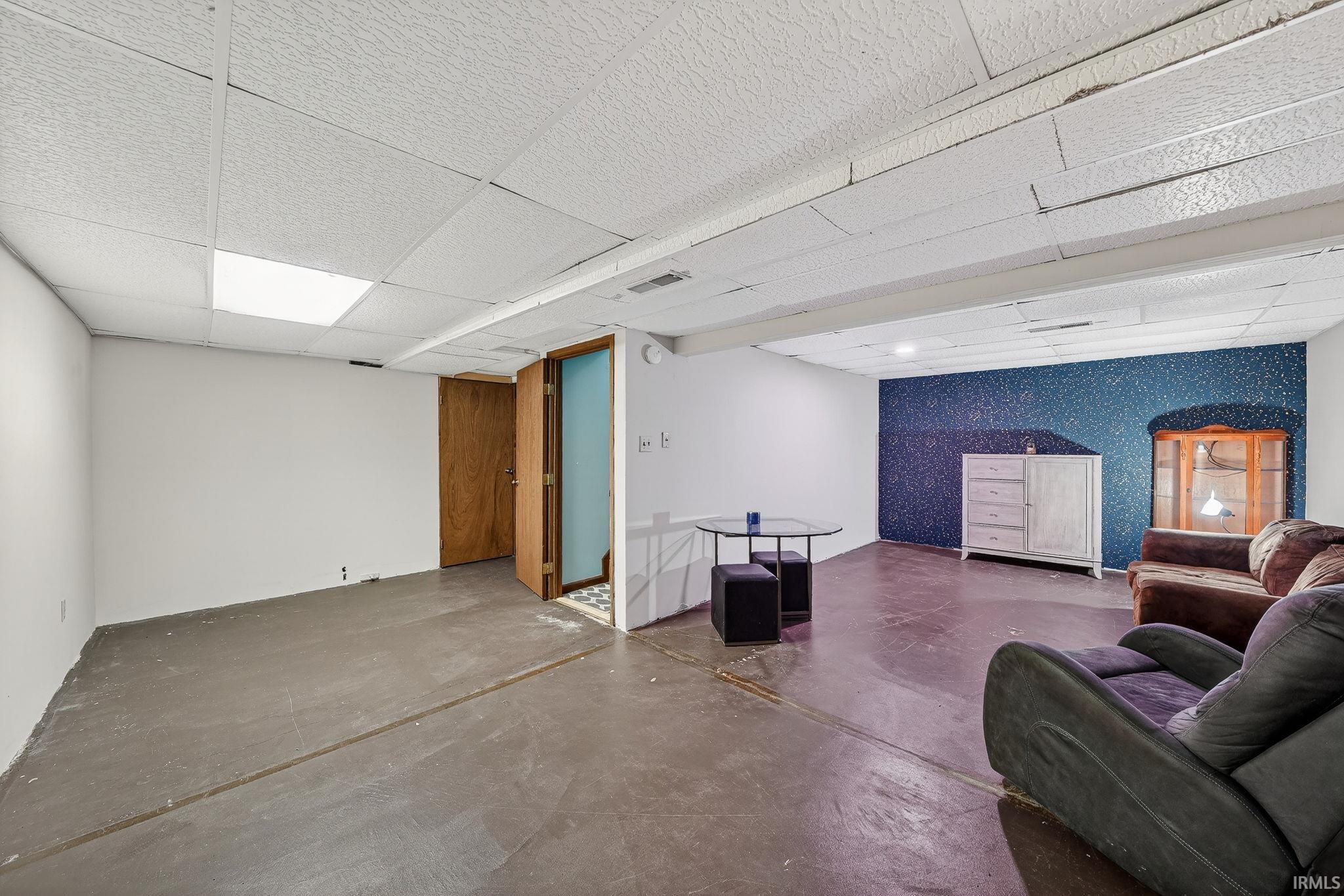 Finished basement with a paneled ceiling